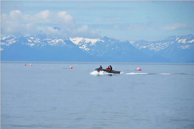 Setnetters make their way back to the beach near a site on July 11, 2016 near Kenai, Alaska. (Photo by Elizabeth Earl/Peninsula Clarion, file)