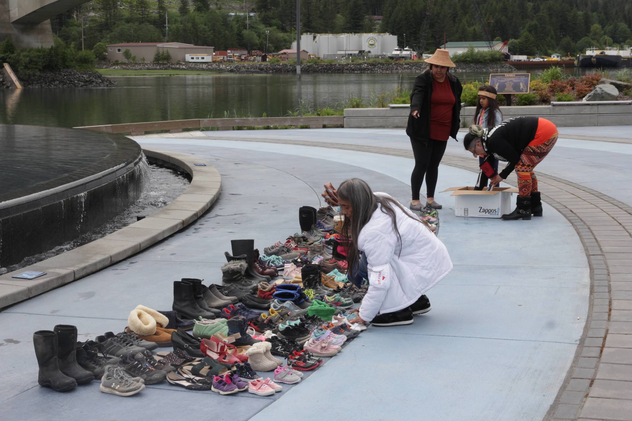 Michael S. Lockett / Juneau Empire
Juneau residents place hundreds of pairs of children’s shoes in front of the statue at Mayor Bill Overstreet Park on Saturday as they mourned for the 215 dead children uncovered at a residential school in Canada.