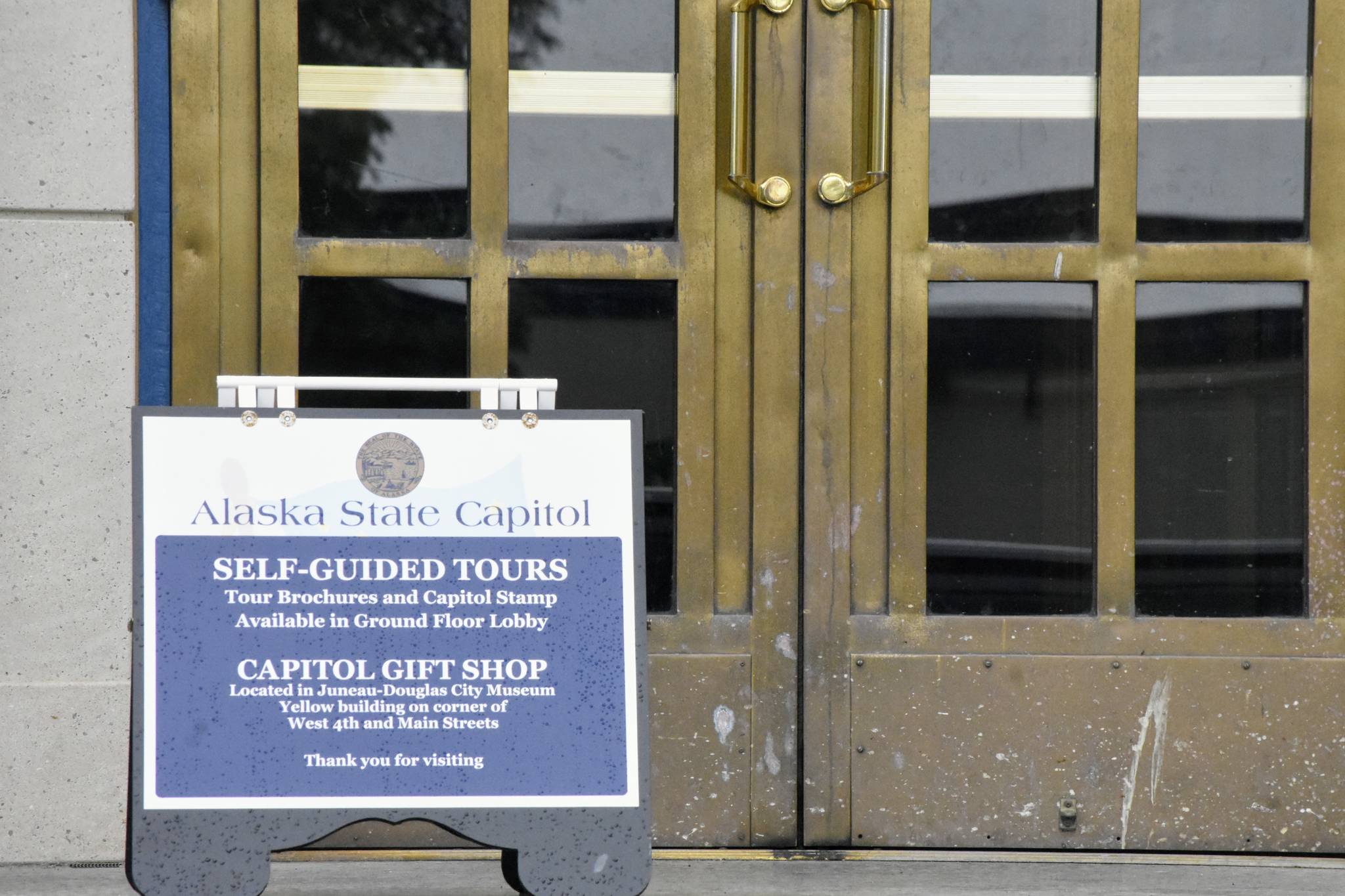 A sign invites visitors into the Alaska State Capitol building on Monday, June 21, 2021. Lawmakers will begin their second special session of the year Wednesday after Gov. Mike Dunleavy sent the state’s budget bill back to lawmakers saying it lacked critical components. (Peter Segall / Juneau Empire)