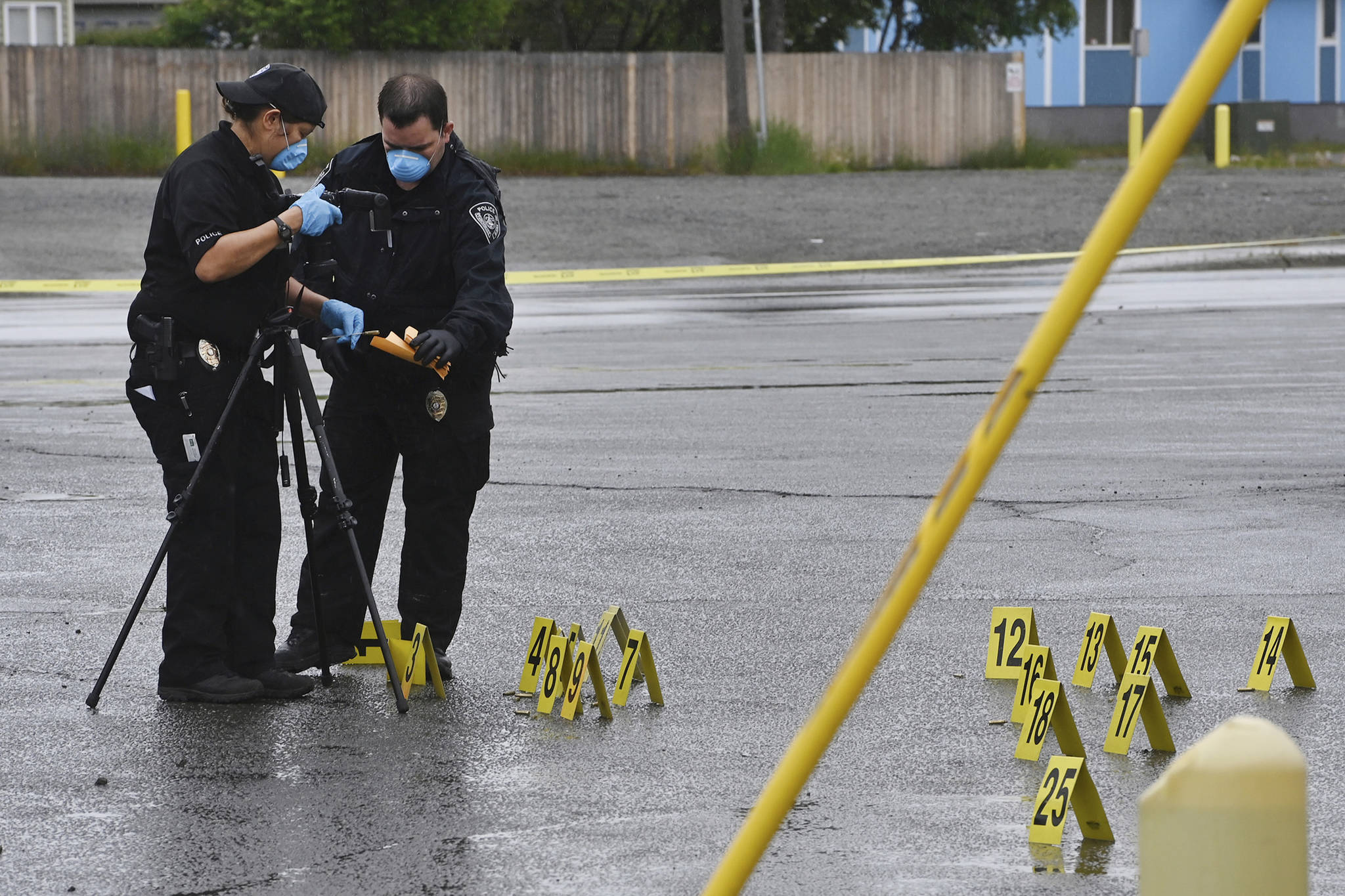 Police investigate the scene of an early morning fatal shooting along Gambell Street between Fourth Avenue and Fifth Avenue near downtown Anchorage, Alaska, Saturday, June 19, 2021. (Bill Roth/Anchorage Daily News via AP)
