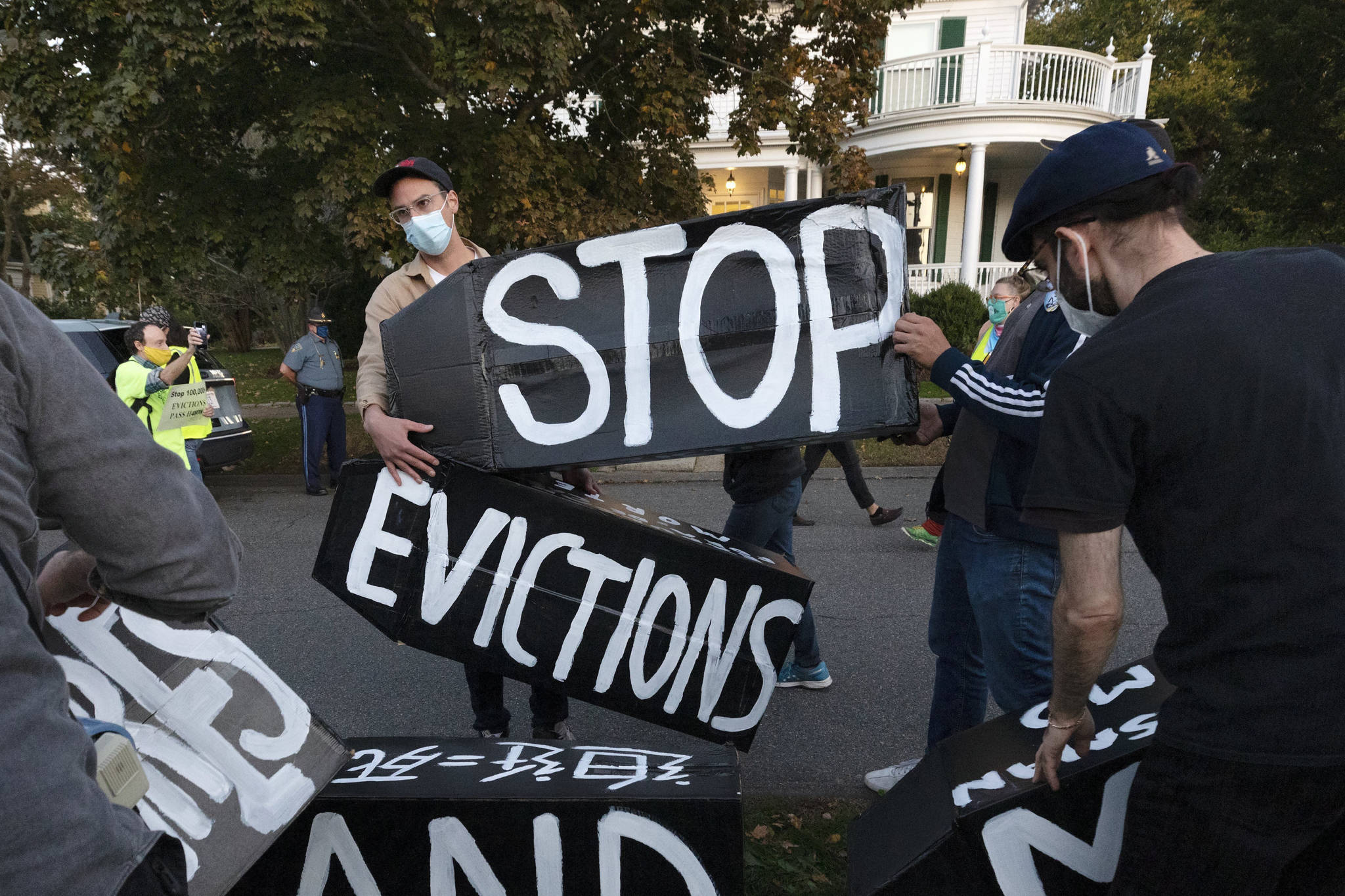 In this Oct. 14, 2020, file photo, housing activists erect a sign in Swampscott, Mass. A federal freeze on most evictions is set to expire soon. The moratorium, put in place by the Centers for Disease Control and Prevention in September, was the only tool keeping millions of tenants in their homes. (AP Photo/Michael Dwyer, File)