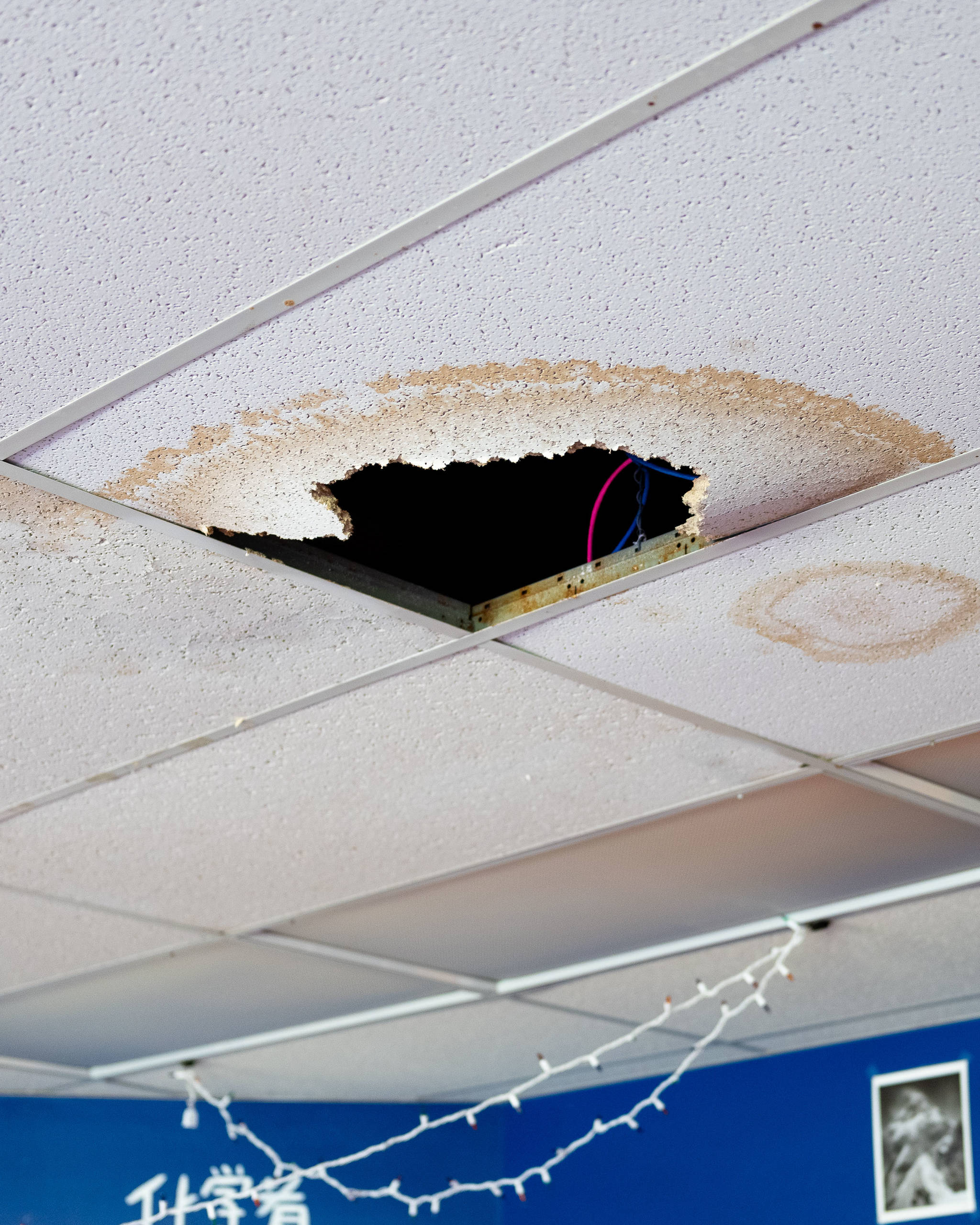 A ceiling panel damaged by water inside a classroom at Seward High School, pictured in May 2021, is the result of a warranty issue that the Kenai Peninsula Borough School District maintenance team said it is working to resolve. (Young Kim for The Hechinger Report)