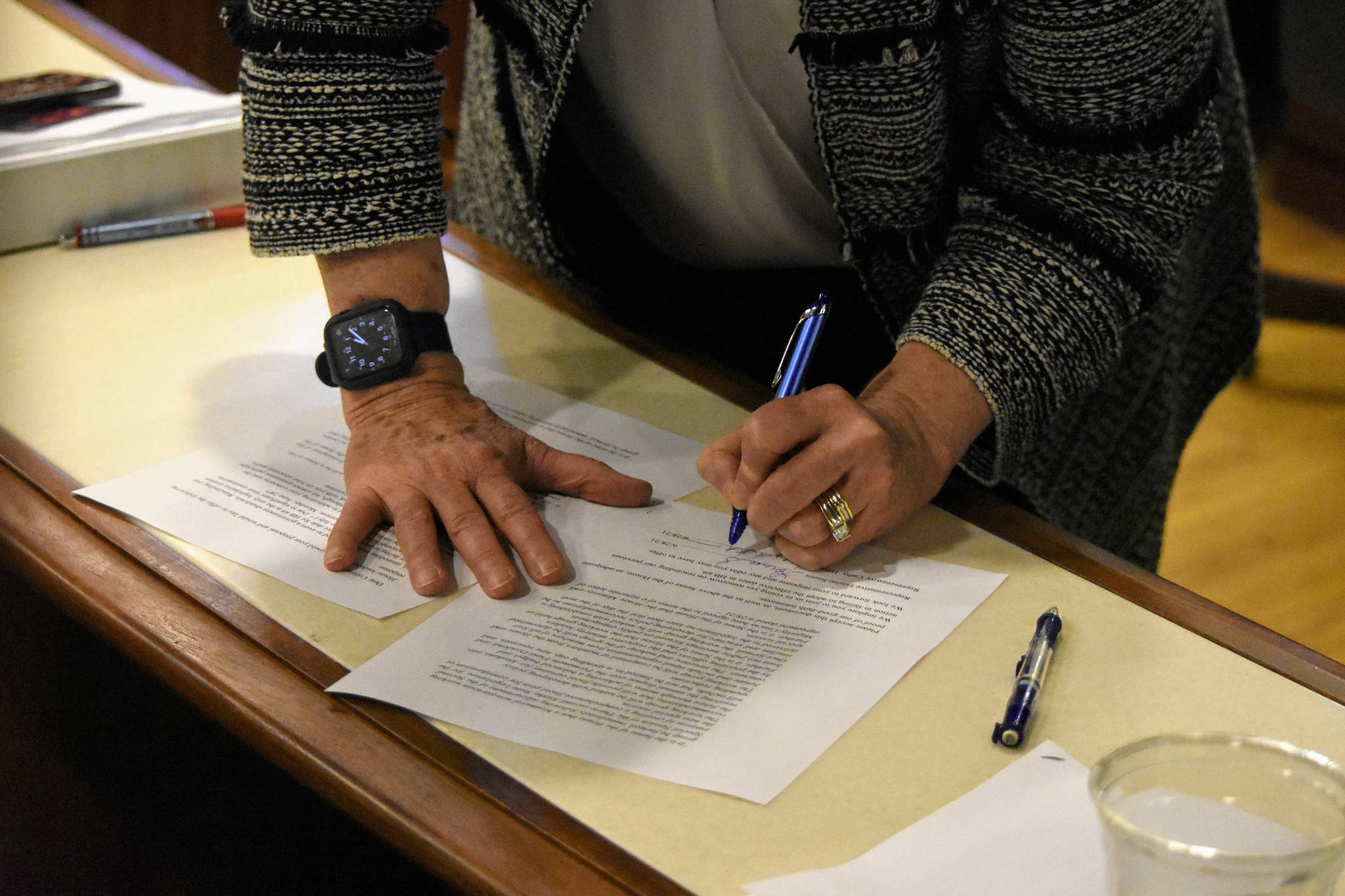 House Speaker Louise Stutes, R-Kodiak, signs an agreement with Minority Leader Cathy Tilton, R-Wasilla, on Monday, June 28, 2021, part of a deal to pass a budget and avoid a government shutdown on July 1. The agreement said lawmakers should form a working group to draft recommendations for resolving the state’s budget deficit at another special session in August. (Peter Segall / Juneau Empire)