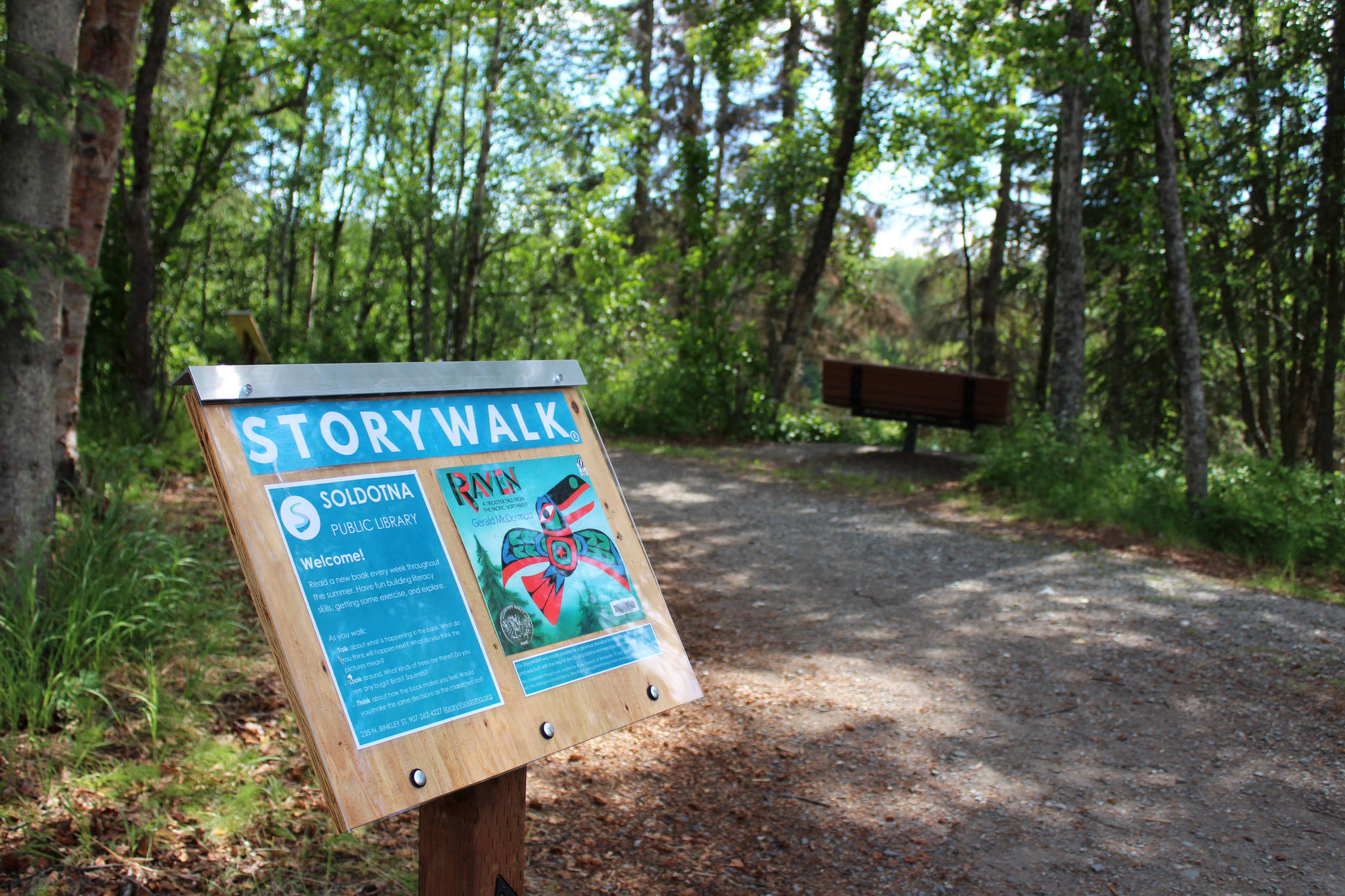 A podium marks the beginning of a StoryWalk at Soldotna Creek Park on Tuesday, June 29, 2021 in Soldotna, Alaska. (Ashlyn O’Hara/Peninsula Clarion)