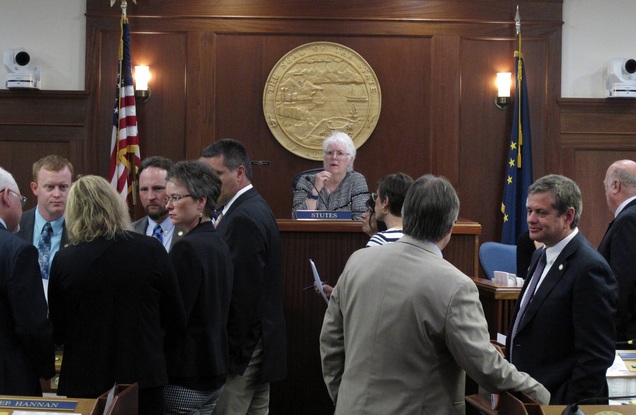 Alaska House Speaker Louise Stutes, center, looks on as groups of legislators meet on the House floor on Monday, June 28, 2021, in Juneau, Alaska. The Alaska Legislature ended its second special session on Monday, after the House acted to adopt effective date provisions attached to a state spending package in a move intended to avert a partial government shutdown. (AP Photo/Becky Bohrer)