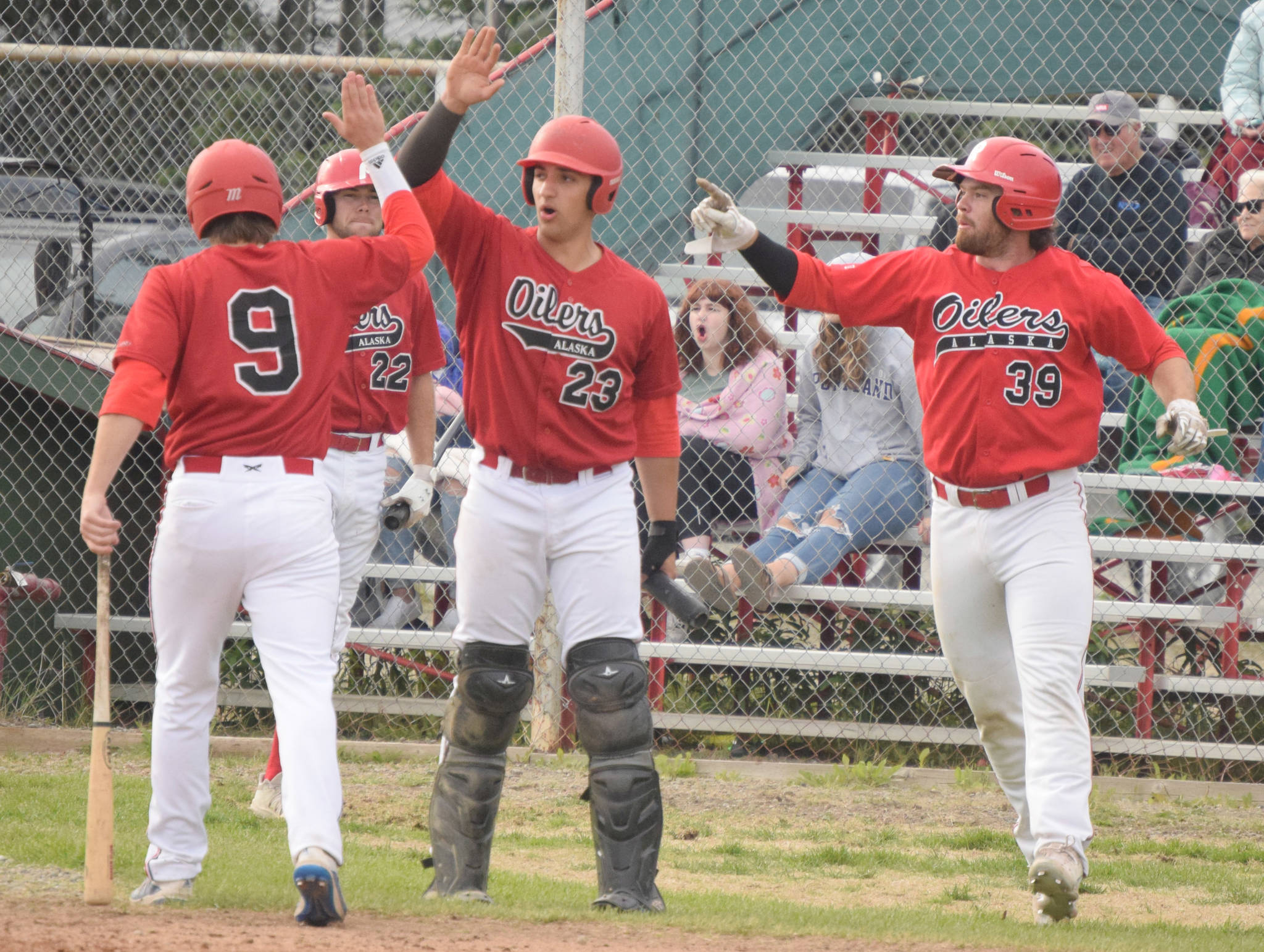 The Peninsula Oilers celebrate a two-run double by Bryce Marsh against the Anchorage Bucs on Tuesday, June 29, 2021, at Coral Seymour Memorial Park in Kenai, Alaska. (Photo by Jeff Helminiak/Peninsula Clarion)