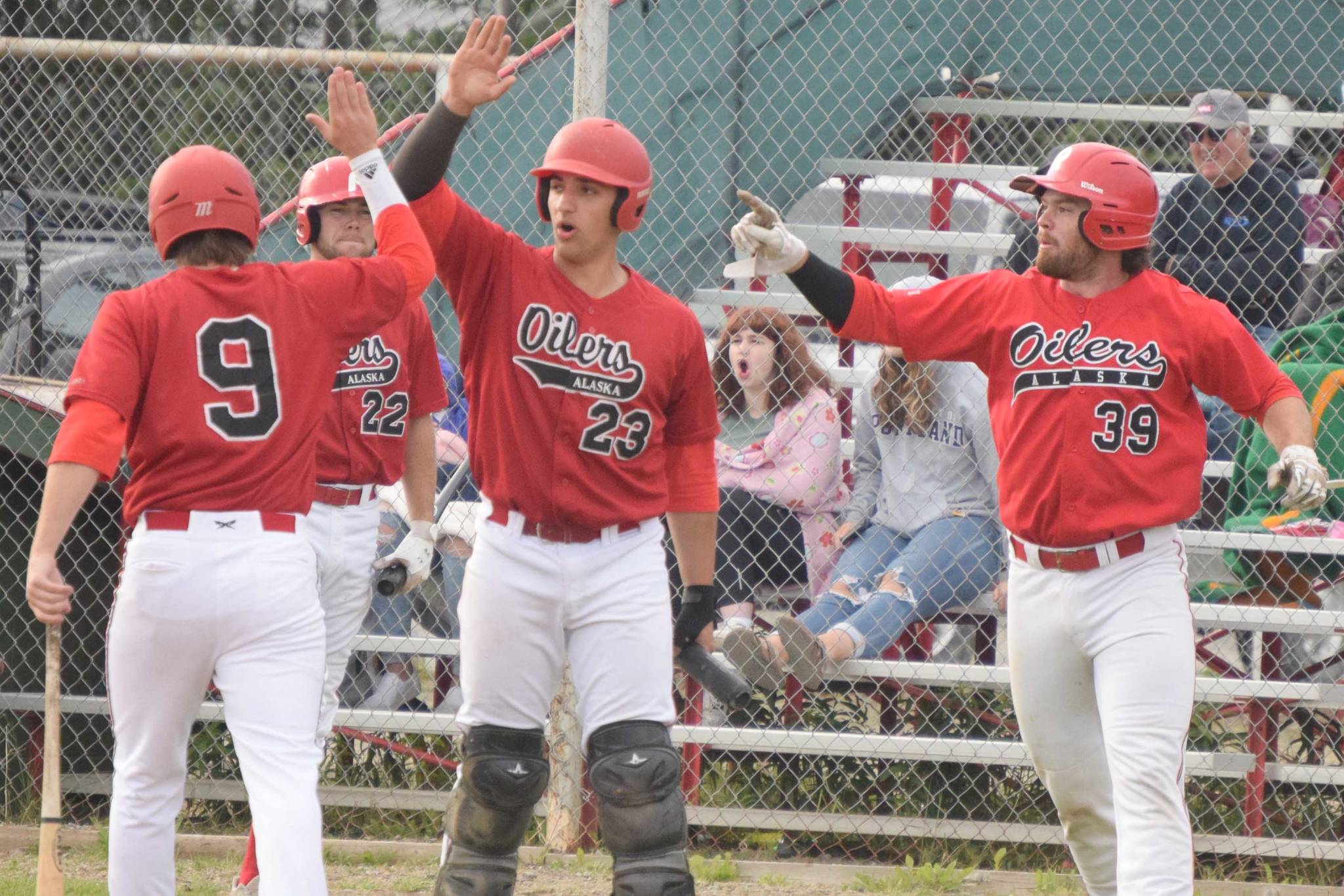 The Peninsula Oilers celebrate a two-run double by Bryce Marsh against the Anchorage Bucs on Tuesday, June 29, 2021, at Coral Seymour Memorial Park in Kenai, Alaska. (Photo by Jeff Helminiak/Peninsula Clarion)