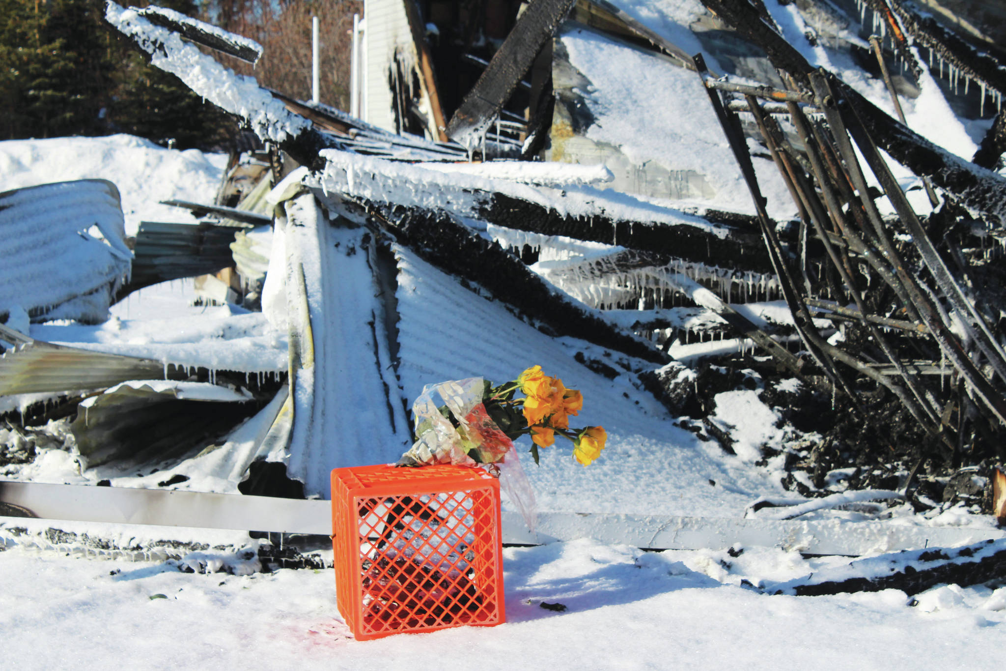 A bouquet of yellow roses is seen at the Triumvirate Theatre on Monday, Feb. 22, 2021, in Nikiski, Alaska. The building burned in a fire on Feb. 20. (Ashlyn O’Hara/Peninsula Clarion)