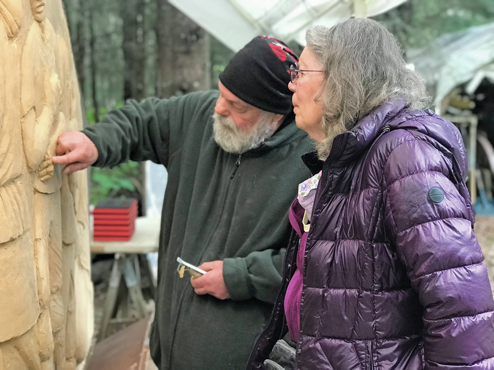 Sara Berg, right, talks with artist Brad Hughes, left, at Hughes’ Homer, Alaska, studio in June 2021 about the Loved & Lost Memorial Bench project Berg and other family and friends of Anesha Murnane commissioned to honor Murnane and other missing woman and children. (Photo by Christina Whiting)