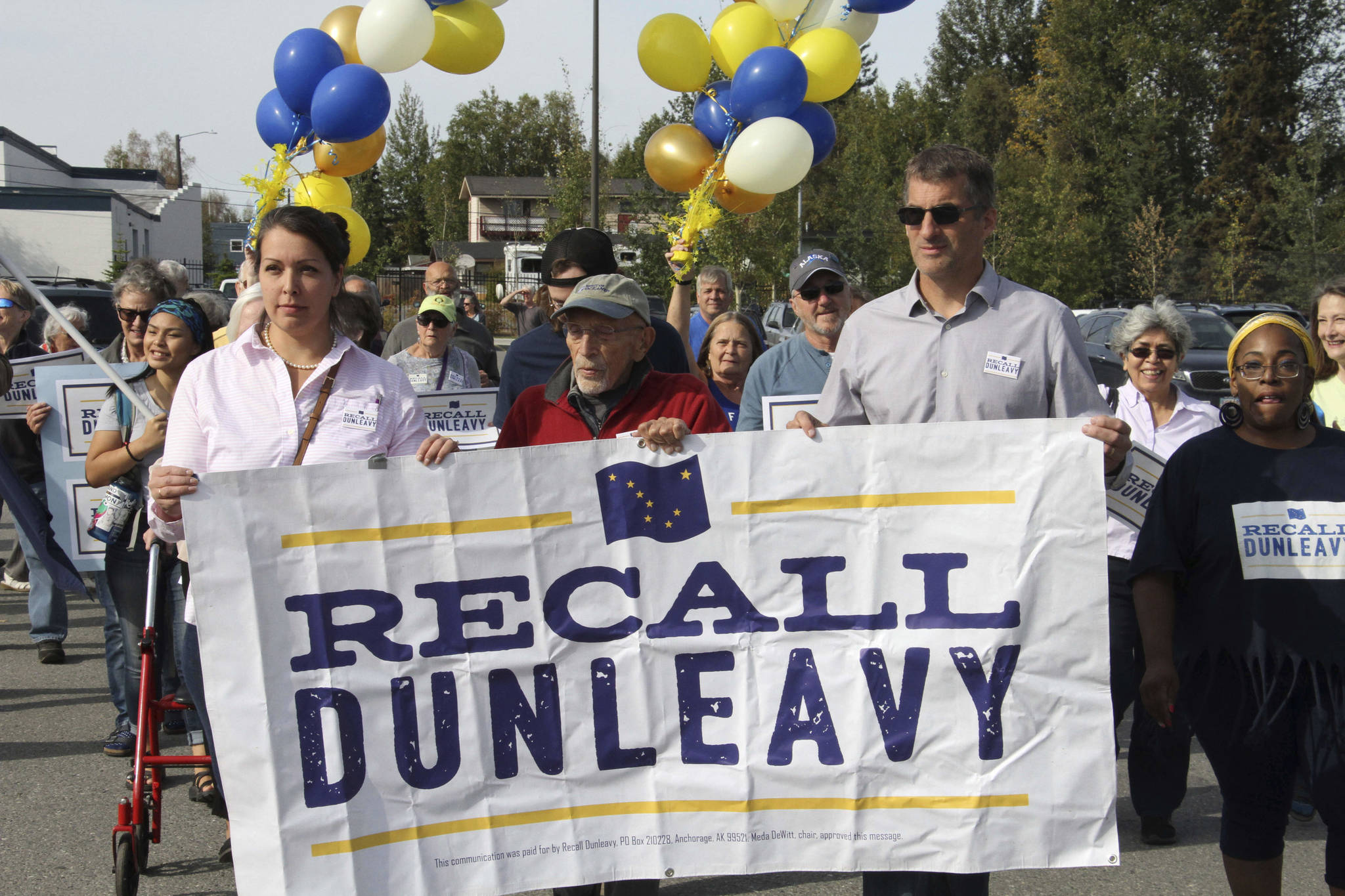 In this Sept. 5, 2019, file photo, Meda DeWitt, left, Vic Fischer, middle, and Aaron Welterlen, leaders of an effort to recall Alaska Gov. Mike Dunleavy, lead about 50 volunteers in a march to the Alaska Division of Elections office in Anchorage, Alaska. The group opposed to Dunleavy has yet to gather enough signatures to force a recall election, nearly two years after launching and with just over a year before the 2022 primary election. (AP Photo/Mark Thiessen, File)