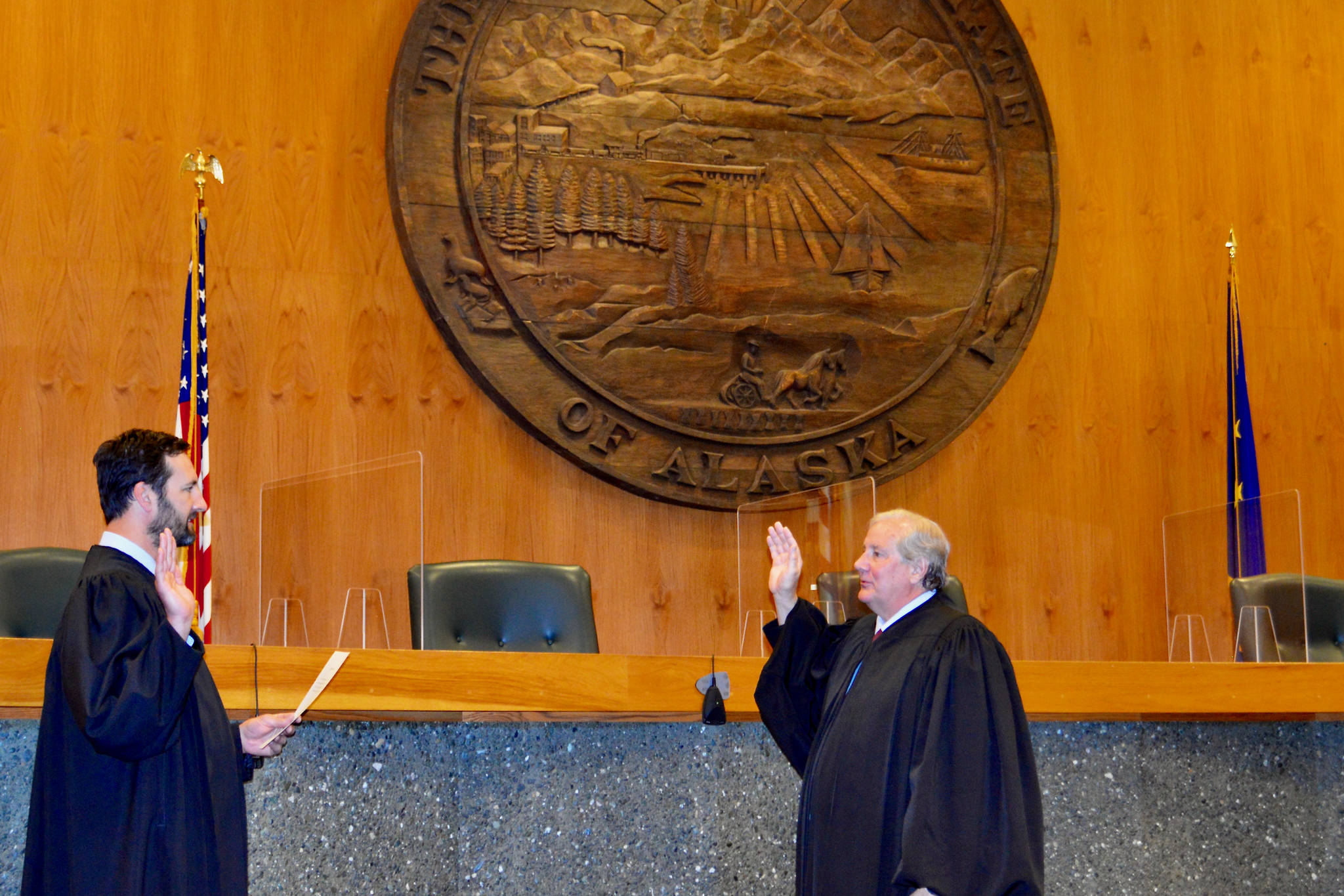 Chief Justice Daniel E. Winfree, right, is sword in by Justice Dario Borghesan in Anchorage on July 1, 2021. Winfree will take over after former Chief Justice Joel Bolger retired earlier this year. (Courtesy photo/Alaska Court System)