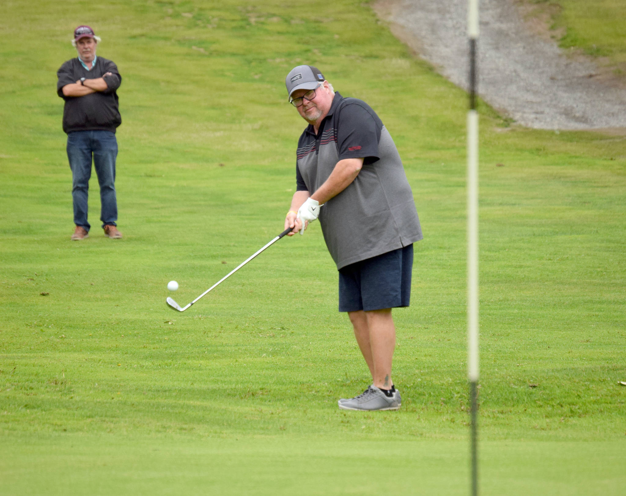 Palmer pro George Collum chips to the fourth green Monday, July 12, 2021, during the State Farm Pro Am and Skins Game at Birch Ridge Golf Course in Soldotna, Alaska. (Photo by Jeff Helminiak/Peninsula Clarion)