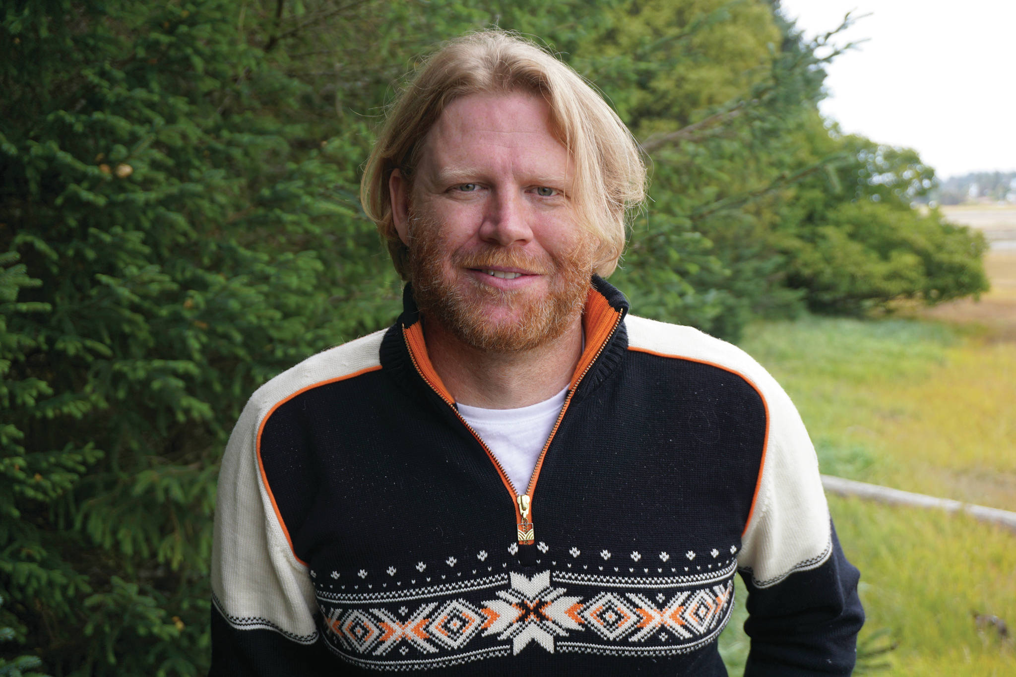 Homer City Council candidate Joey Evensen poses for a photo on Sept. 6, 2019, by Beluga Slough at his Homer, Alaska, home. (Photo by Michael Armstrong/Homer News)