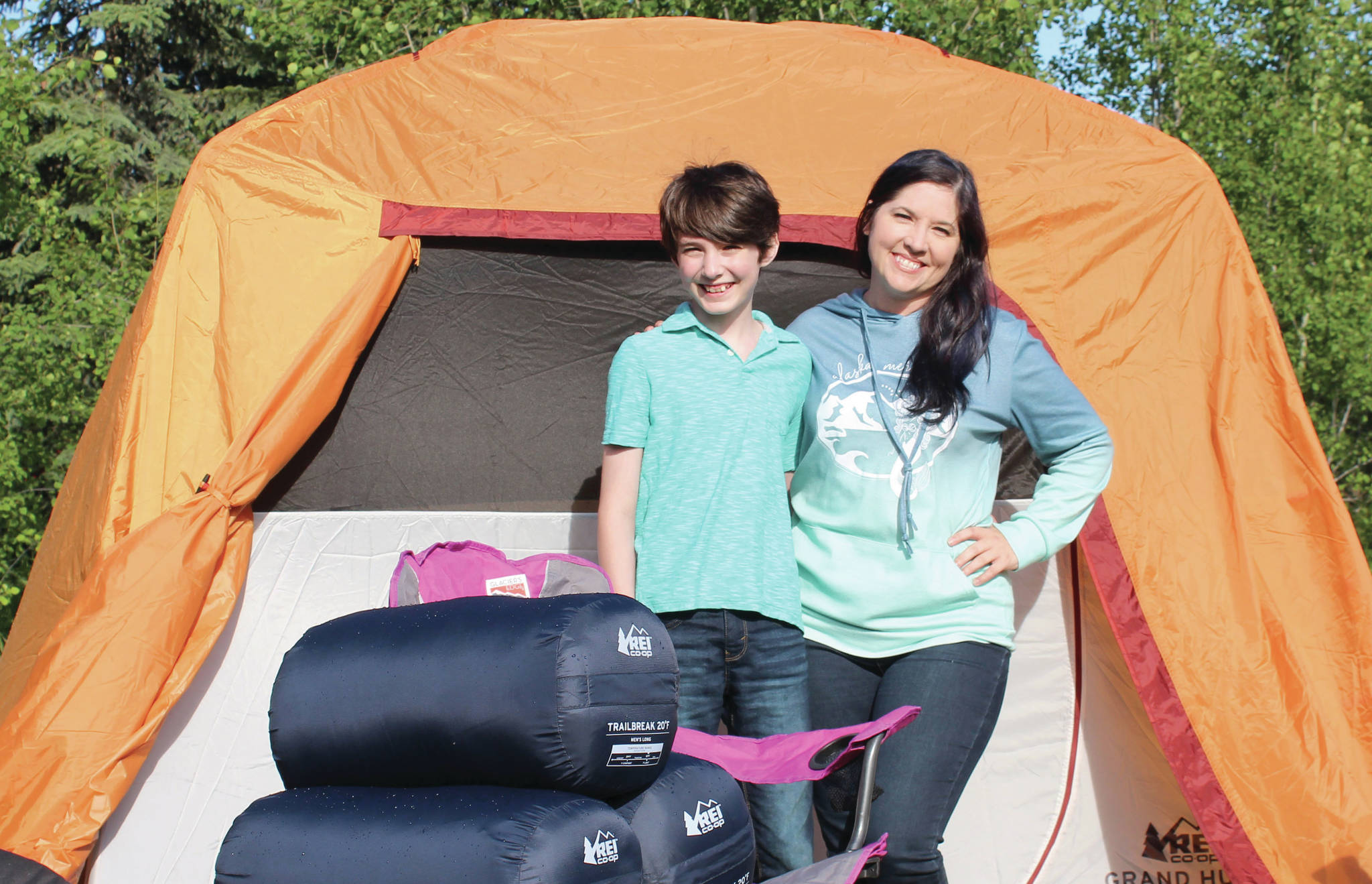 Ashlyn O’Hara / Peninsula Clarion 
Koebryn and Summer Lazenby stand in front of camping gear Tuesday at Summer’s house near Soldotna.