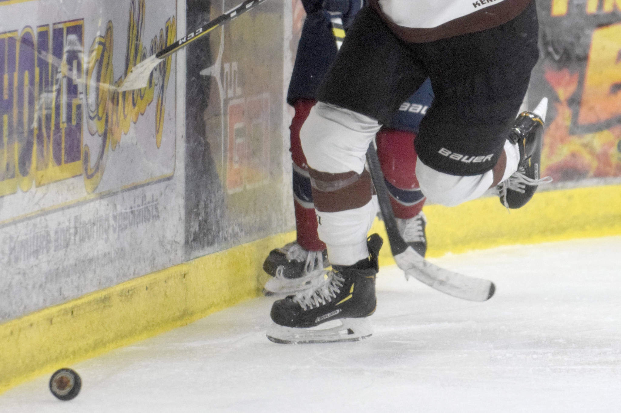 Kenai River Brown Bears forward Max Helgeson chases the puck along the boards against the Fairbanks Ice Dogs on Friday, Nov. 22, 2019, at the Soldotna Regional Sports Complex in Soldotna, Alaska. (Photo by Jeff Helminiak/Peninsula Clarion)