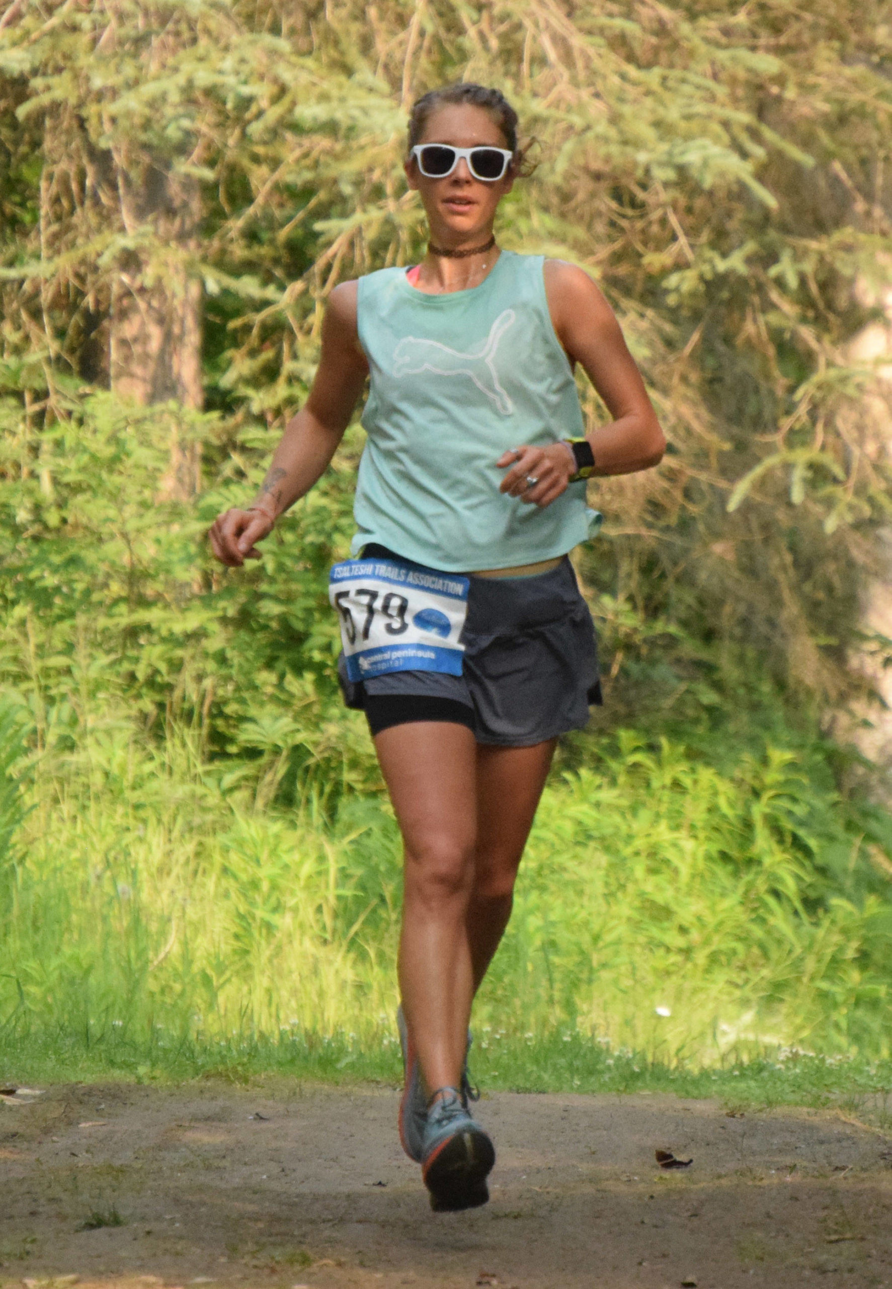 Shelby Dykstra, of Soldotna, runs to victory in the 10-kilometer event at the Rotary Unity Run on Saturday, July 17, 2021, at Tsalteshi Trails just outside of Soldotna, Alaska. (Photo by Jeff Helminiak/Peninsula Clarion)