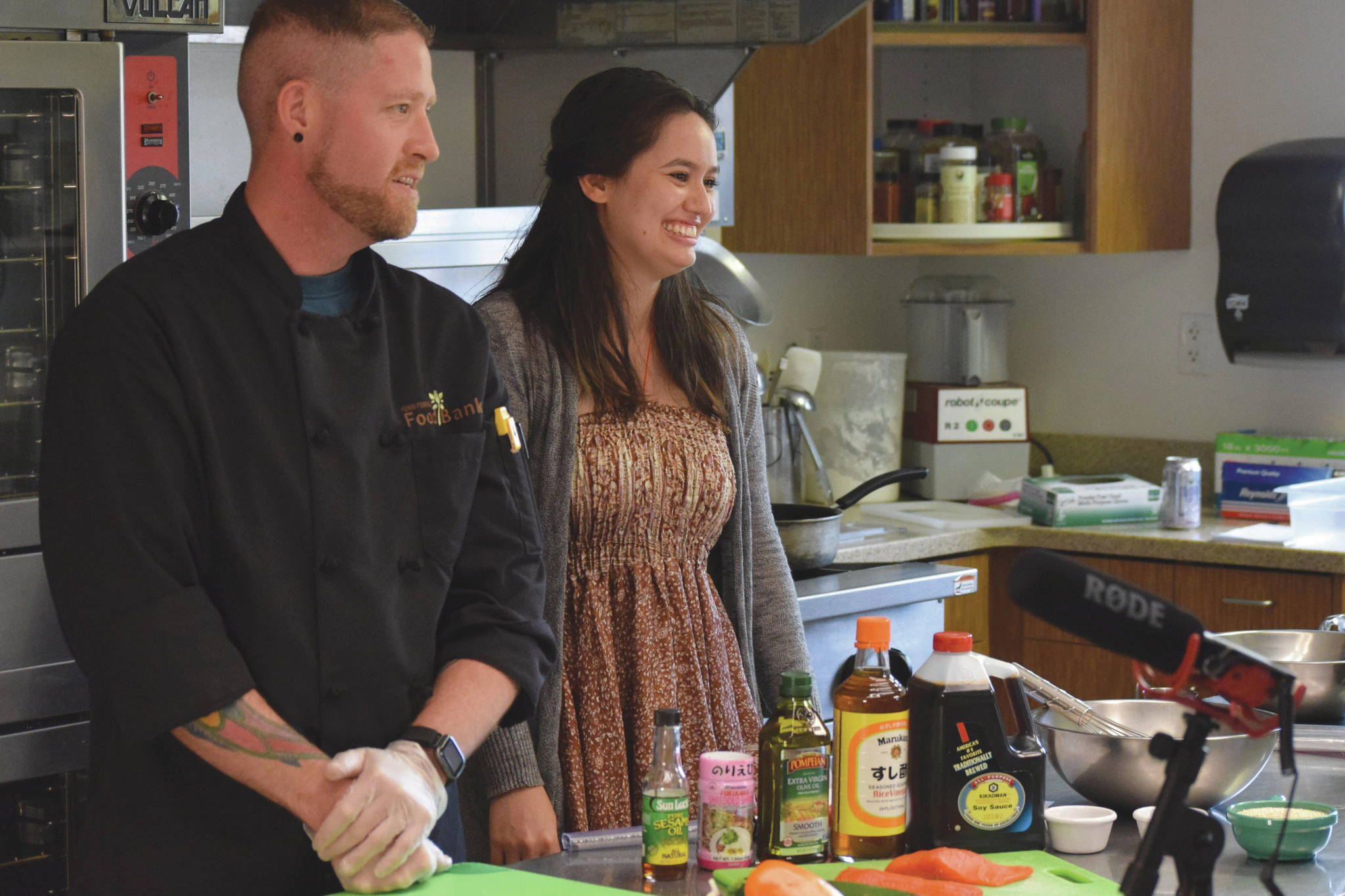 Stephen Lamm and Lilly Murray film a culinary video for the Kenai Peninsula Food Bank's healthy lifestyle eating promotional program Monday, July 19, 2021, at the food bank diner just outside of Soldotna. (Photo by Camille Botello/Peninsula Clarion)