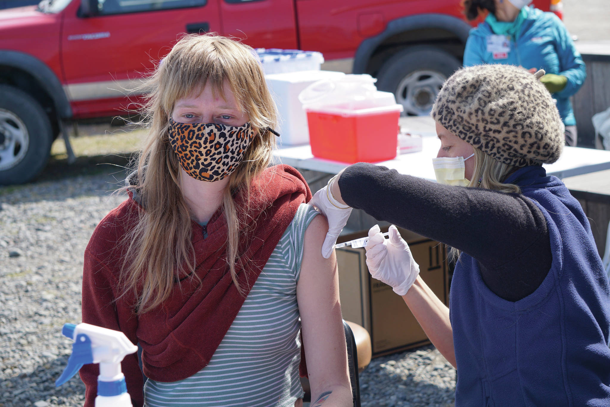 South Peninsula Hospital registered nurse Anne Garay gives Jessica Entsminger her second COVID-19 vaccine on Friday, May 7, 2021, at a pop-up vaccination clinic at the Boathouse Pavillion on the Homer Spit in Homer, Alaska. About 25 people received vaccines in the first 3.5 hours of the 4-hour clinic. (Photo by Michael Armstrong/Homer News)