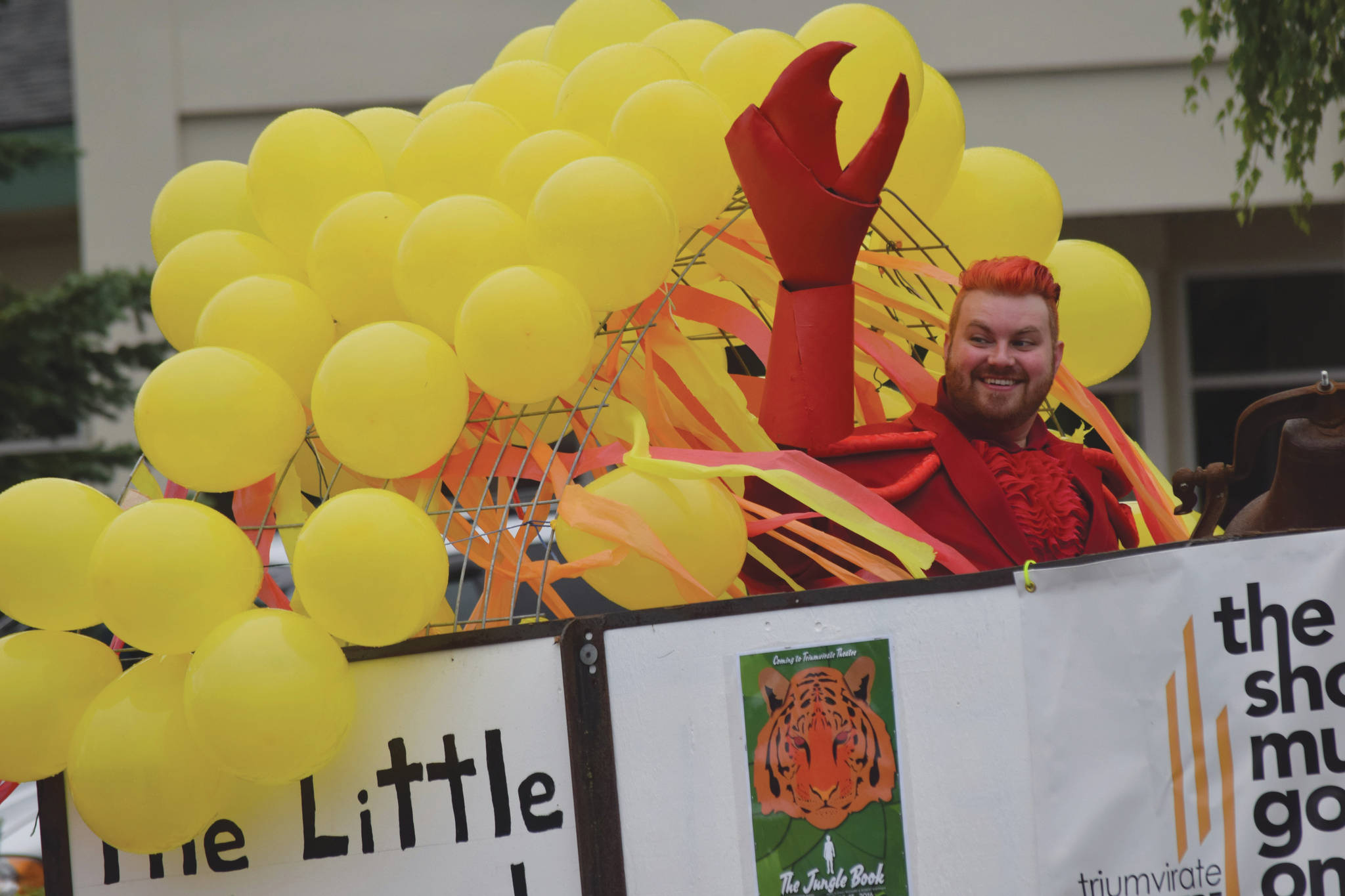 Camille Botello / Peninsula Clarion 
Characters from the “Little Mermaid” wave to the crowd from the Triumvirate Theatre float during the Soldotna Progress Days parade on Saturday in Soldotna. This is the first year the Progress Days festival expanded to take place over four days.