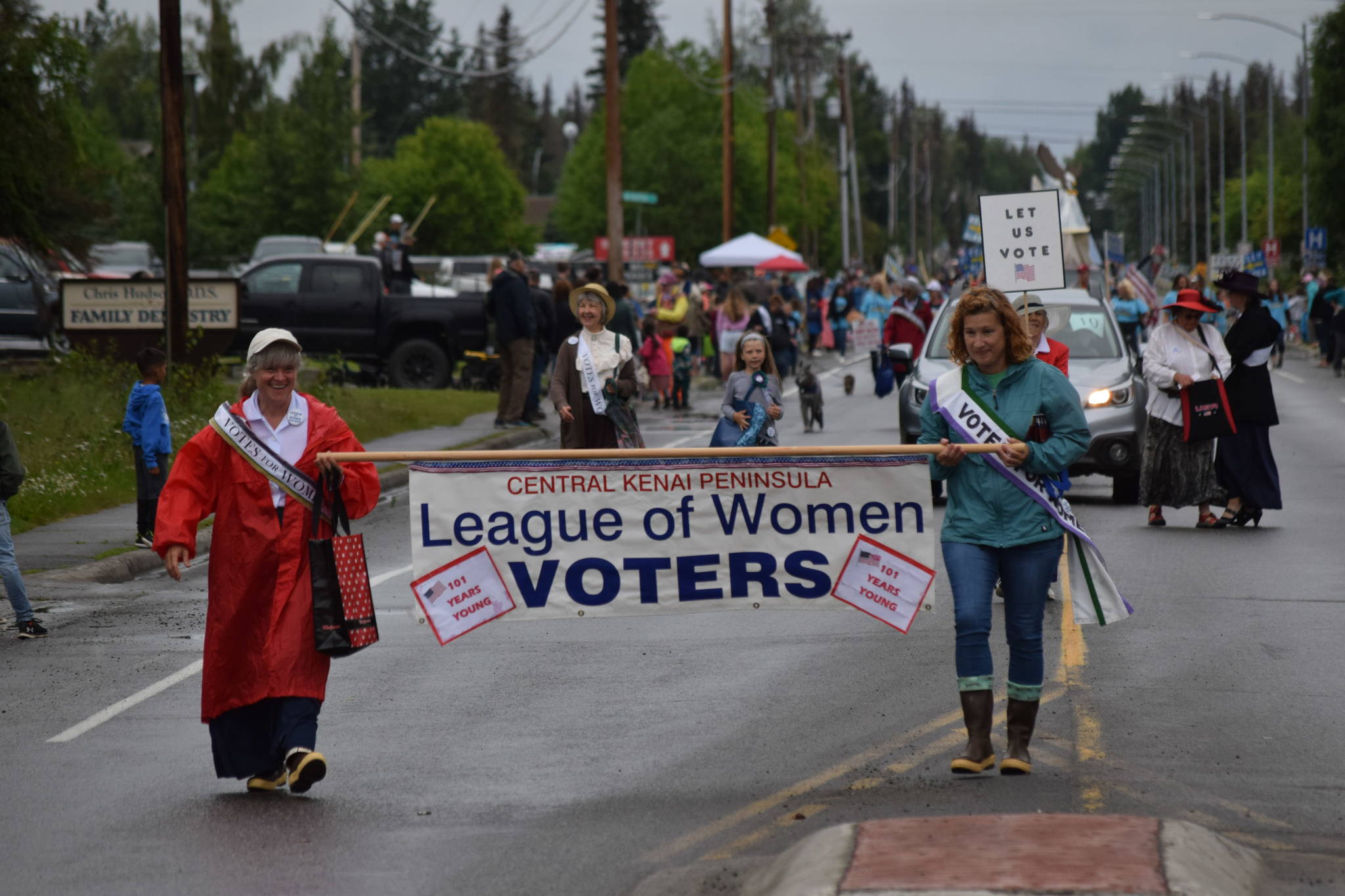 Members of the League of Women Voters wave to the crowd during the Soldotna Progress Days parade on Saturday, July 24, 2021. (Camille Botello / Peninsula Clarion)