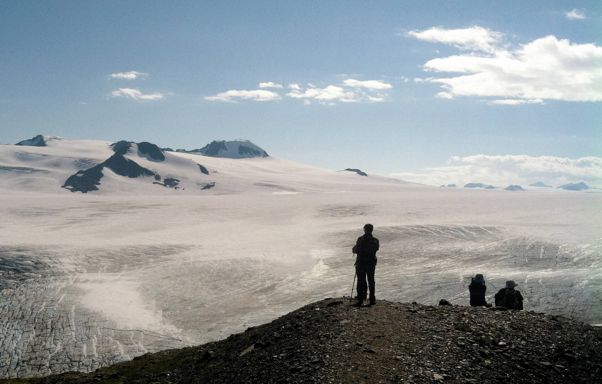 Hikers look at the Harding Icefield in August 2015 in Kenai Fjords National Park, just outside of Seward, Alaska. (Photo by Jeff Helminiak/Peninsula Clarion)