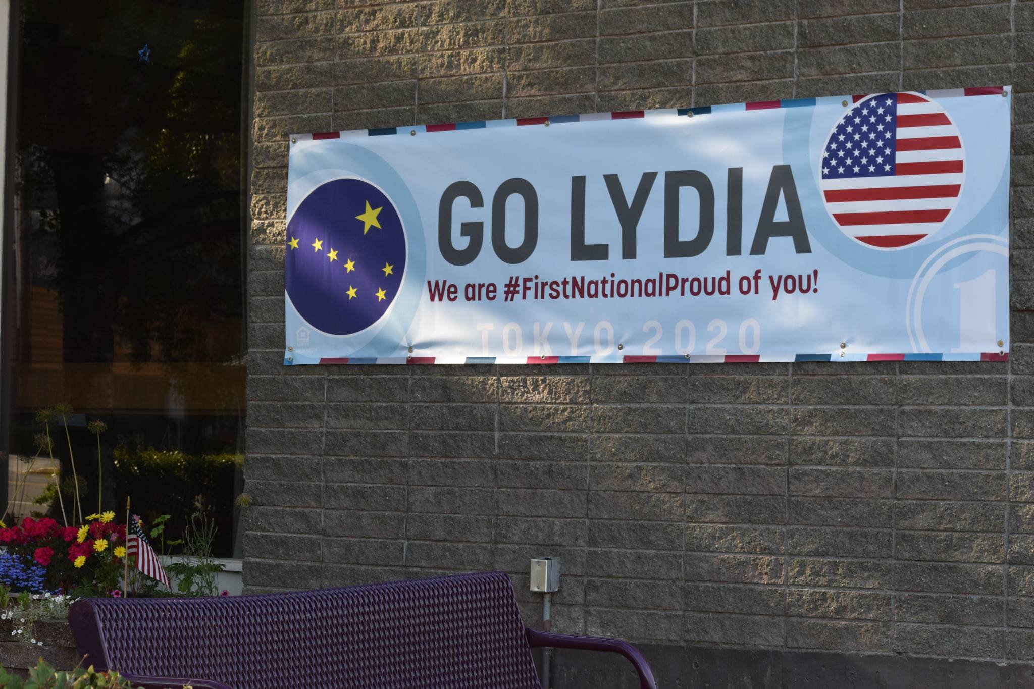 A banner supporting Olympic swimmer Lydia Jacoby hangs outside of First National Bank Alaska in her hometown of Seward on Saturday, July 24, 2021. (Camille Botello / Peninsula Clarion)