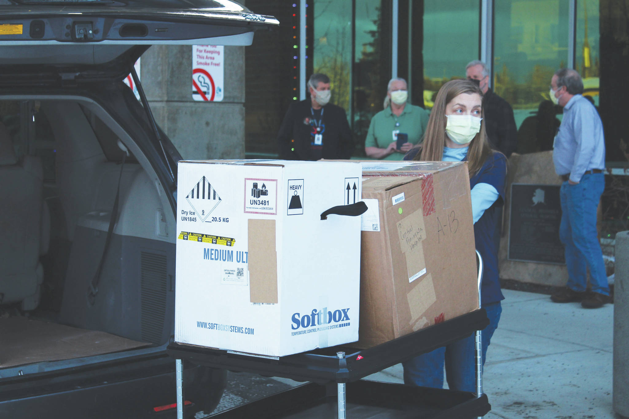 Central Peninsula Hospital Pharmacy Technician Jessica Hulet rolls a cart carrying doses of Pfizer's COVID-19 vaccine into Central Peninsula Hospital on Wednesday, Dec. 16 in Soldotna, Alaska. (Ashlyn O'Hara/Peninsula Clarion)