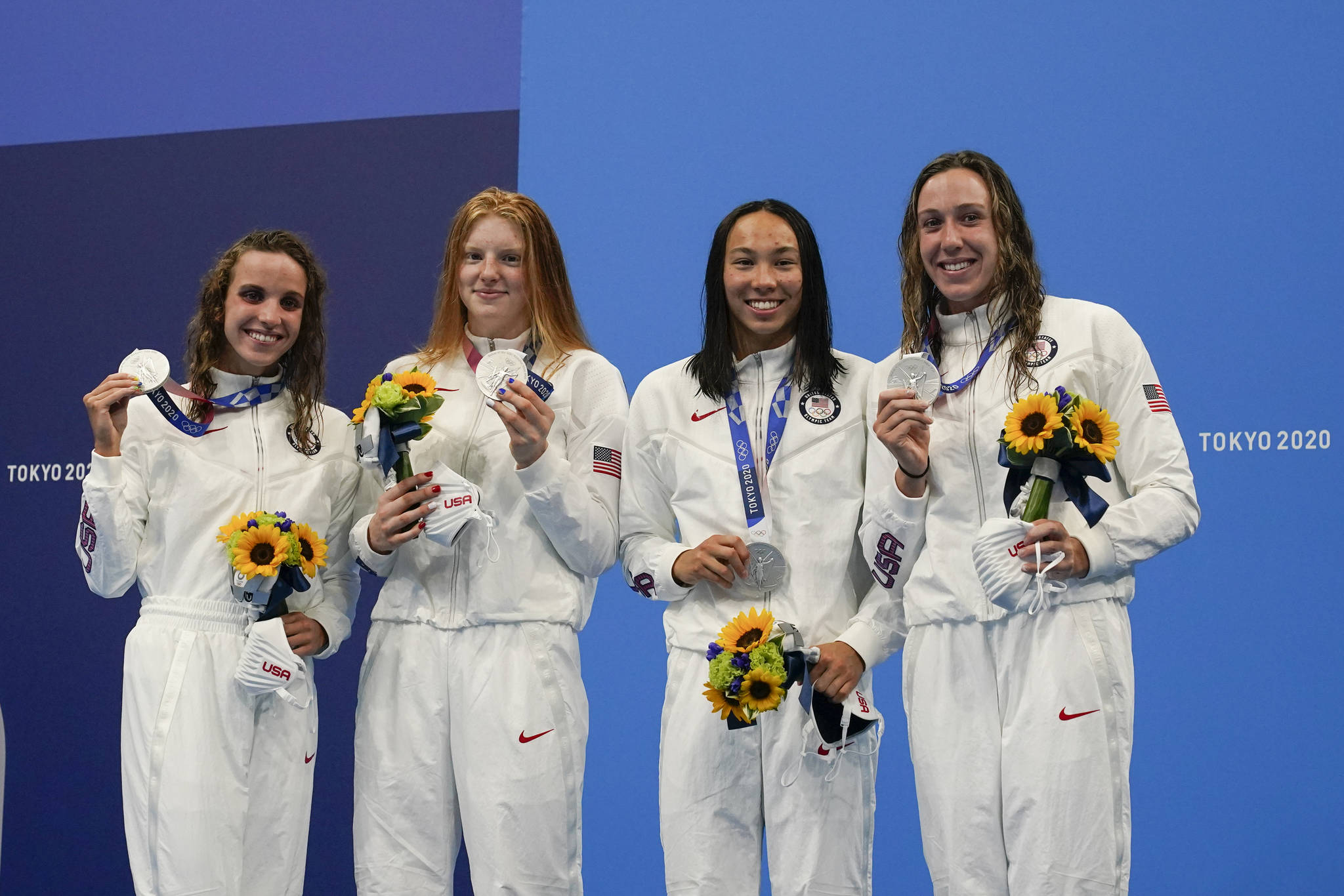 The United States’ women’s 4x100-meter medley relay team, Regan Smith, Lydia Jacoby, Torri Huske and Abbey Weitzeil, celebrates at the podium after winning the silver medal at the 2020 Summer Olympics, Sunday, Aug. 1, 2021, in Tokyo, Japan. (AP Photo/Gregory Bull)