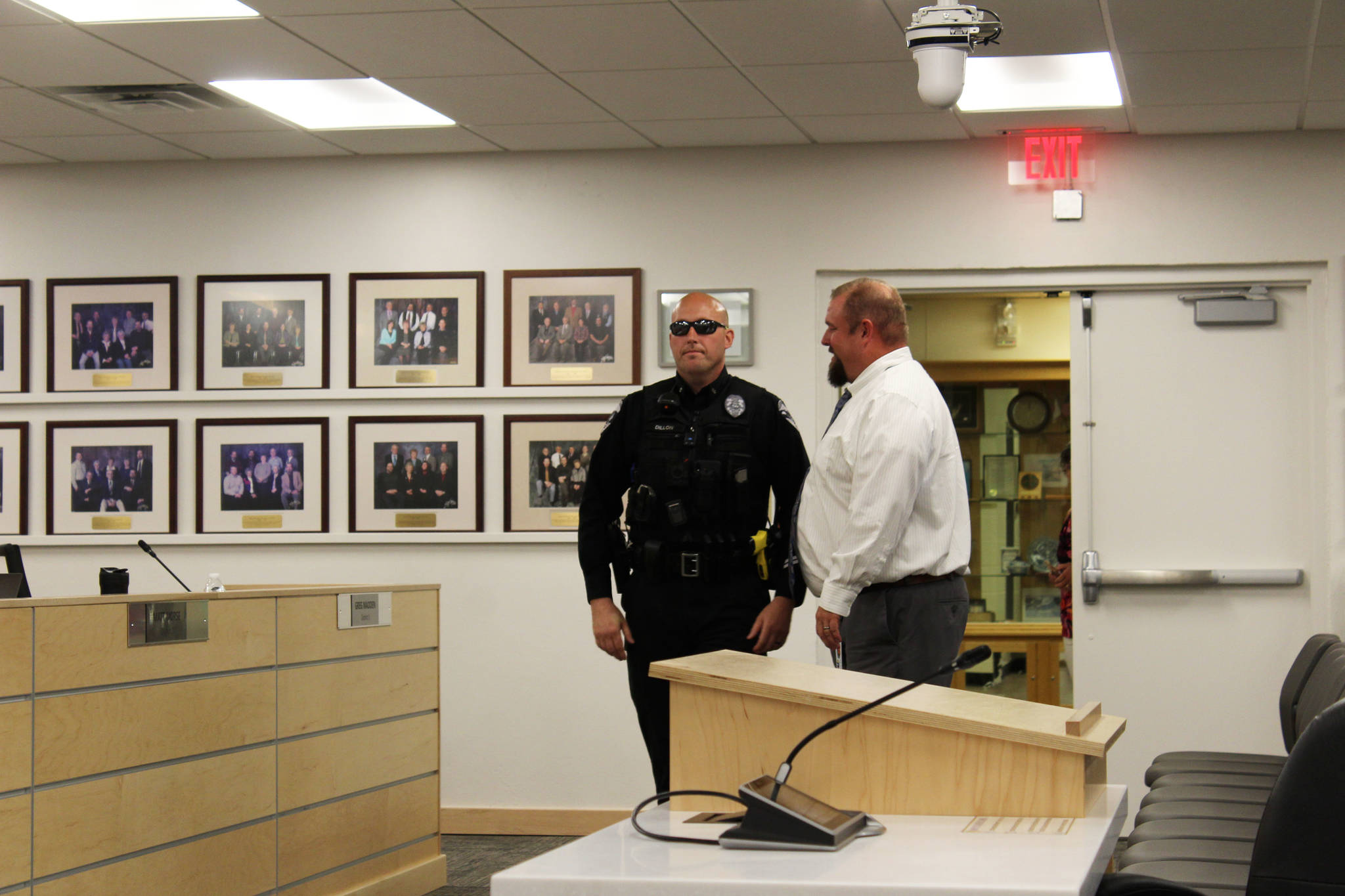 Soldotna Police Department Officer Victor Dillon speaks with Kenai Peninsula Borough School District Director of Secondary Education Tony Graham at the George A. Navarre Borough Admin building on Monday, Aug. 2, 2021 in Soldotna, Alaska. (Ashlyn O’Hara/Peninsula Clarion)