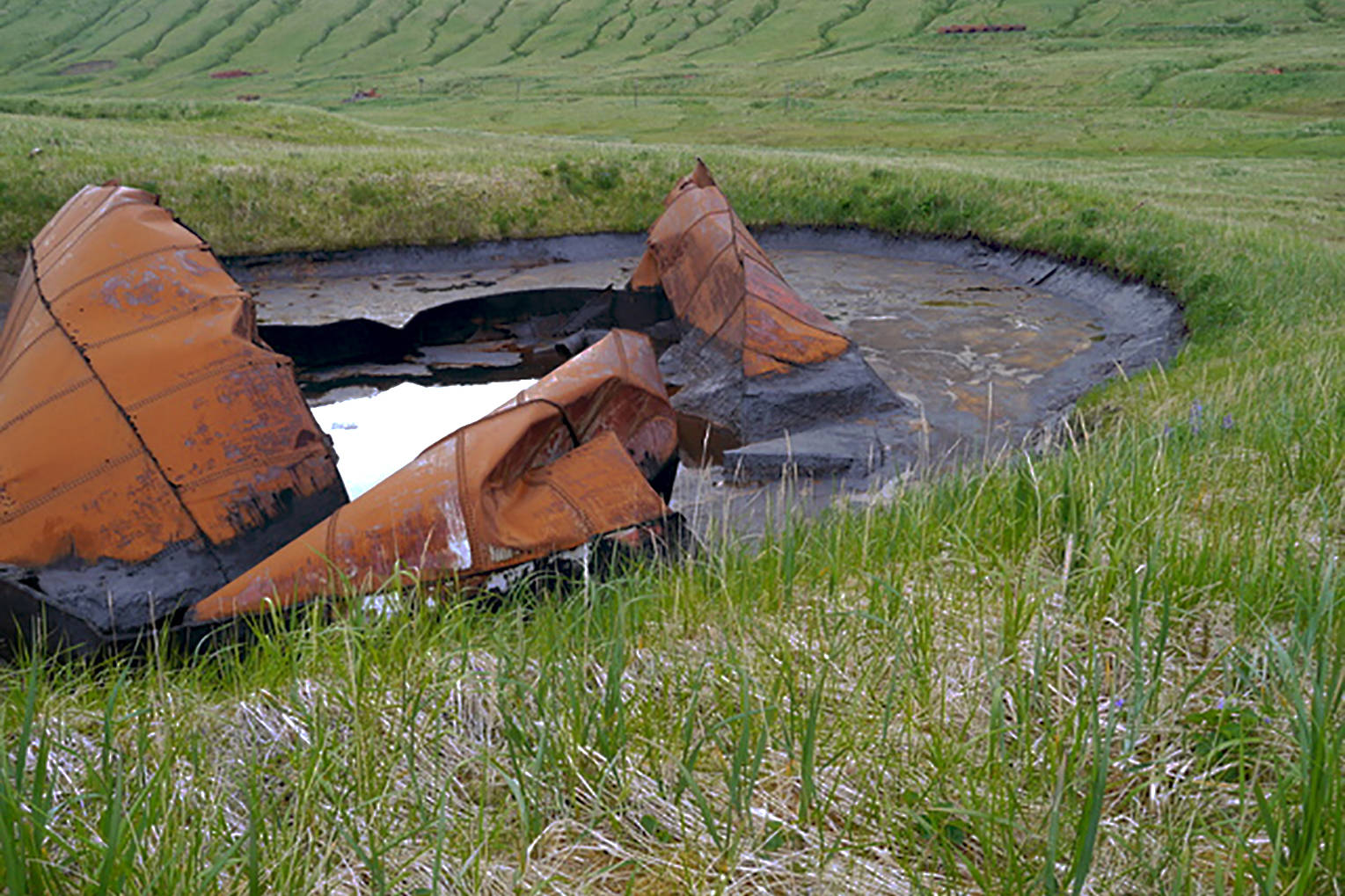 Some tanks were breached with explosives and the fuel set on fire, a method of eliminating fuel that was not very successful. (USFWS)
Some tanks were breached with explosives and the fuel set on fire, a method of eliminating fuel that was not very successful. (USFWS)