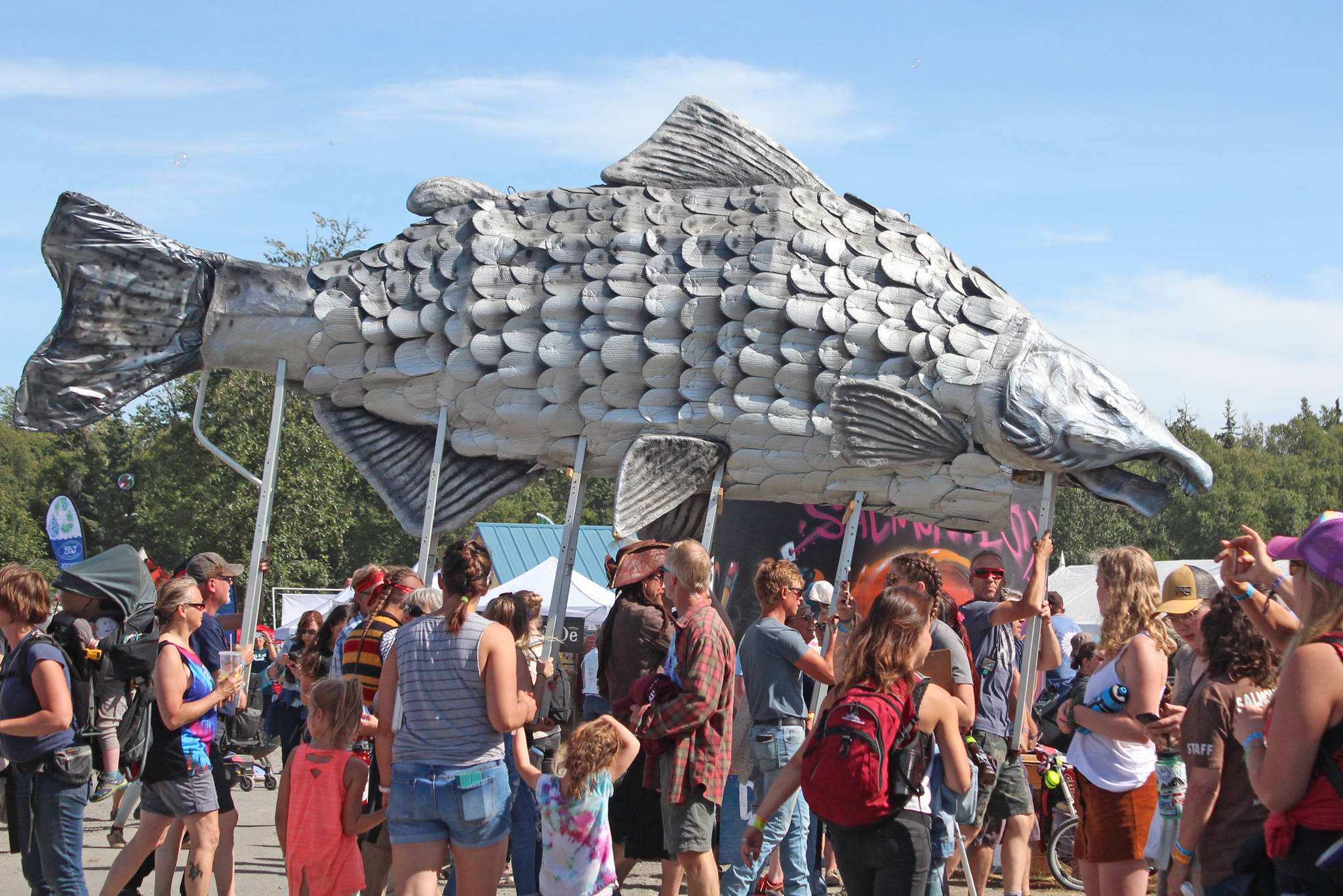 A giant silver salmon is paraded through Salmonfest on Saturday, Aug. 3, 2019 in Ninilchik, Alaska. (Photo by Megan Pacer/Homer News)