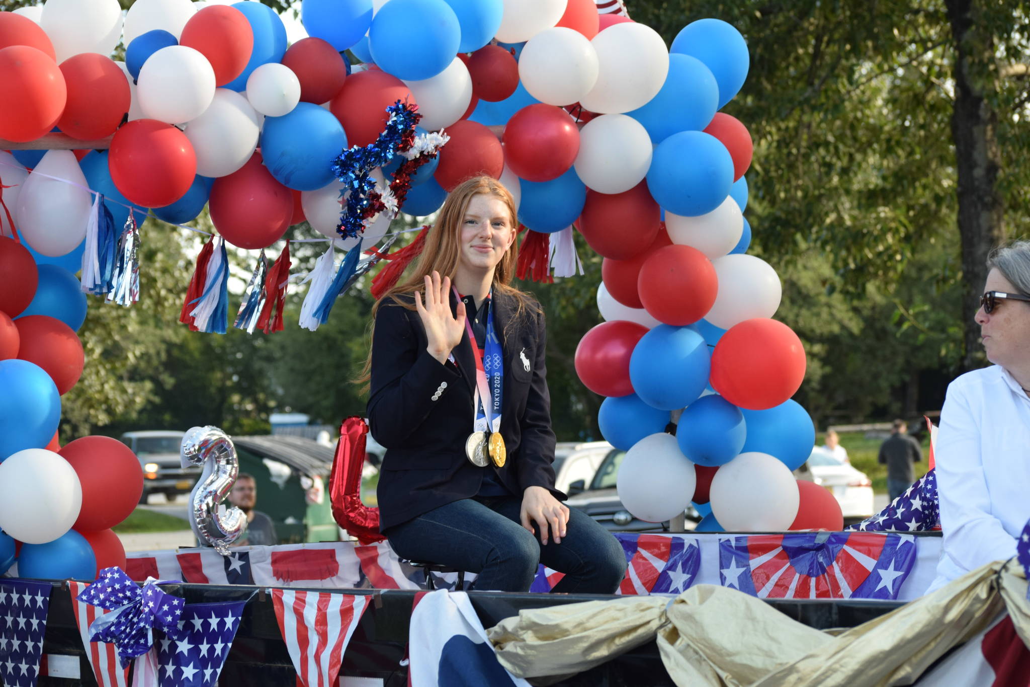Olympic gold medalist Lydia Jacoby waves to the crowd in Seward during her celebratory parade on Thursday, August 5, 2021. (Camille Botello / Peninsula Clarion)