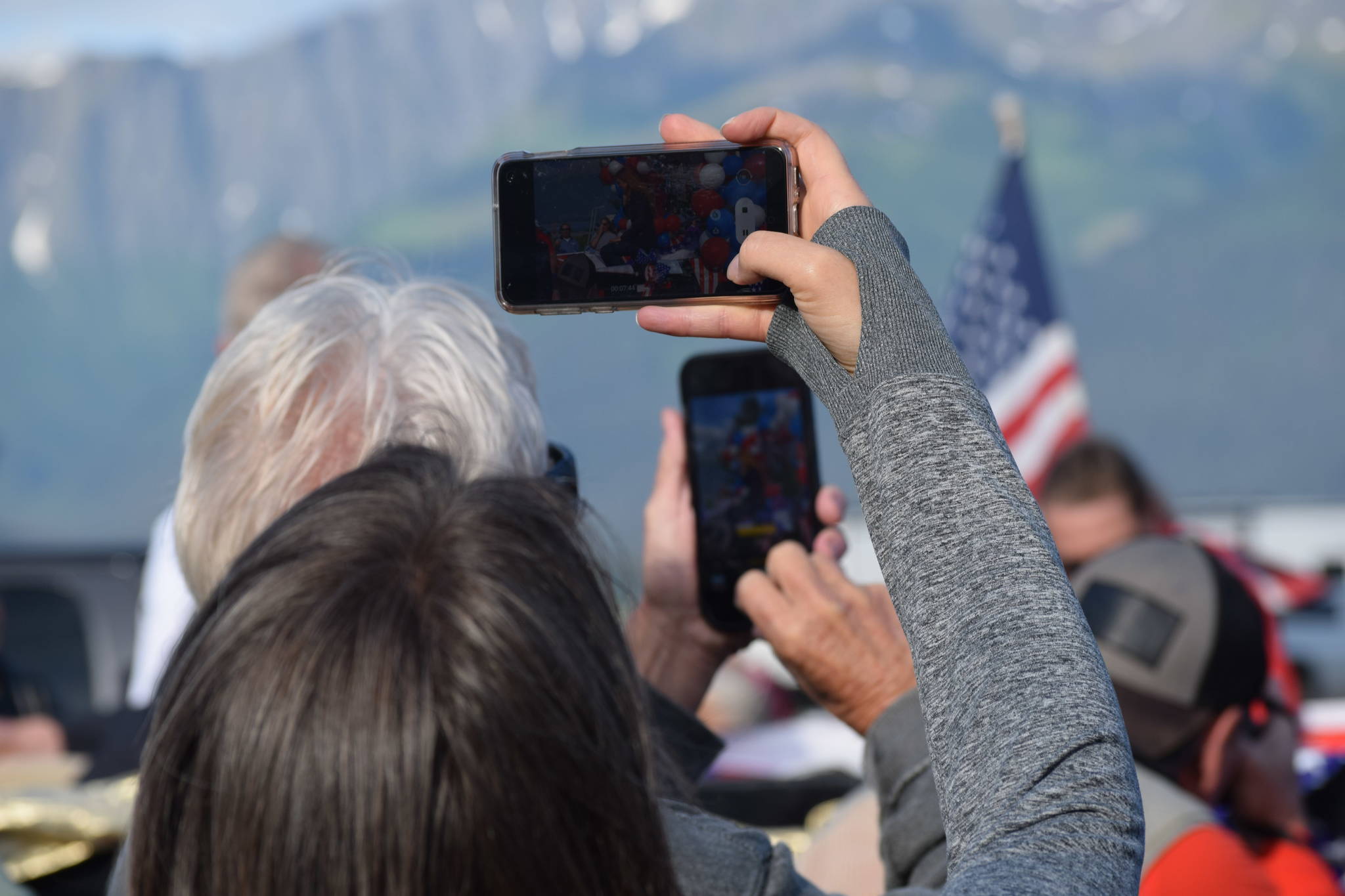 The crowd takes photos as Olympic gold medalist Lydia Jacoby passes through Seward during her celebratory parade on Thursday, August 5, 2021. (Camille Botello / Peninsula Clarion)