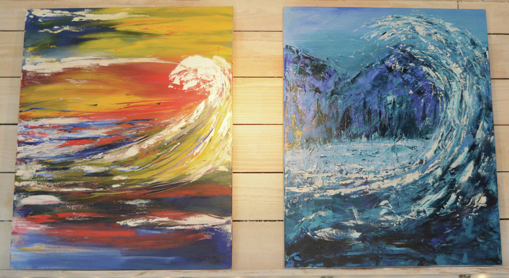 Two of Tracy Hansen’s more recent paintings, “Waves of Emotion: Anxiety,” left, and “Waves of Emotion: Peace,” right, are on display Tuesday, Aug. 11, 2021, at her shop, 59 North, in Homer, Alaska. (Photo by Michael Armstrong/Homer News)