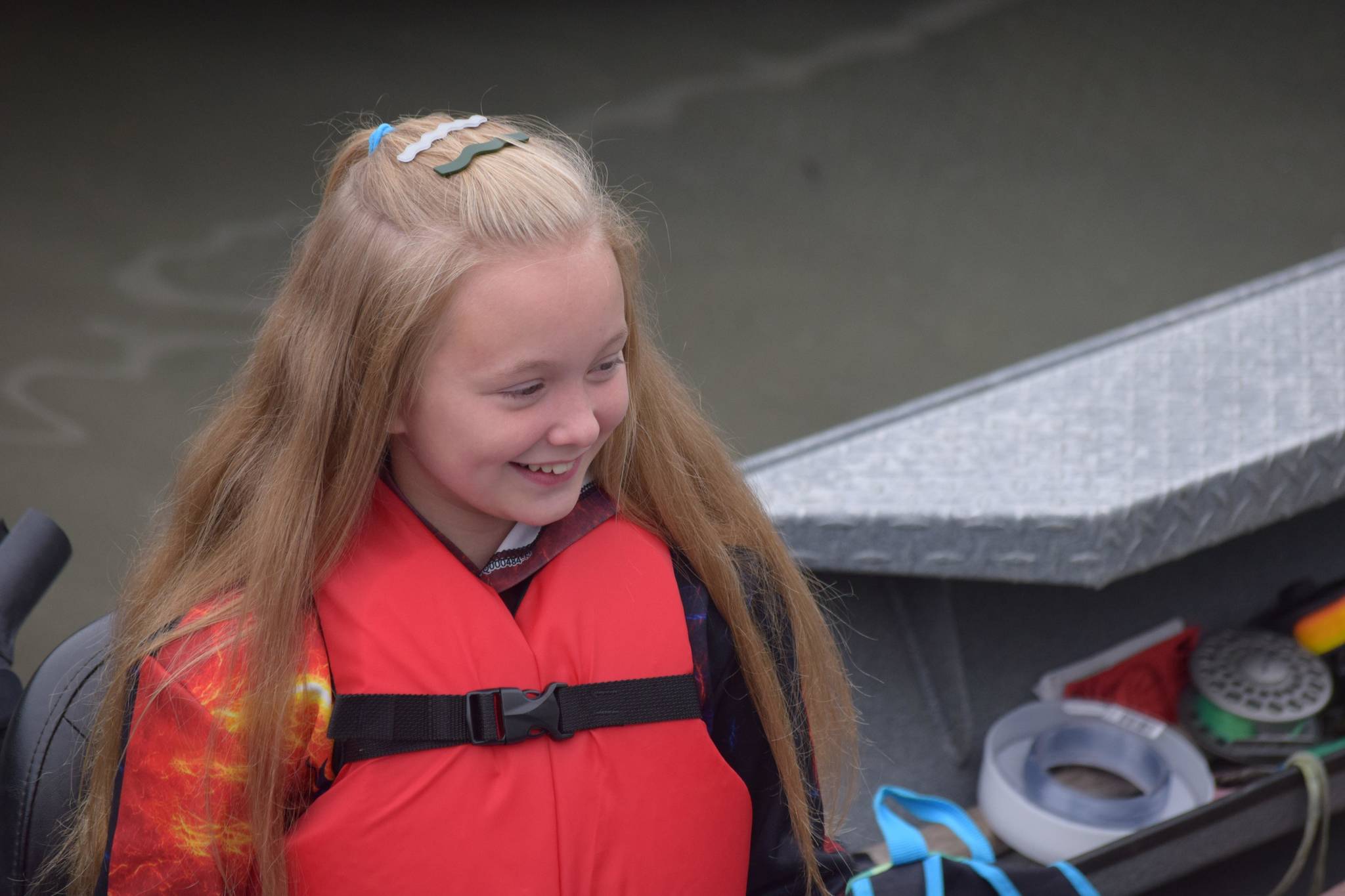 A young angler participates in the Kenai River Junior Classic on the Kenai River in Soldotna, Alaska, on Wednesday, Aug. 11, 2021. (Camille Botello / Peninsula Clarion)