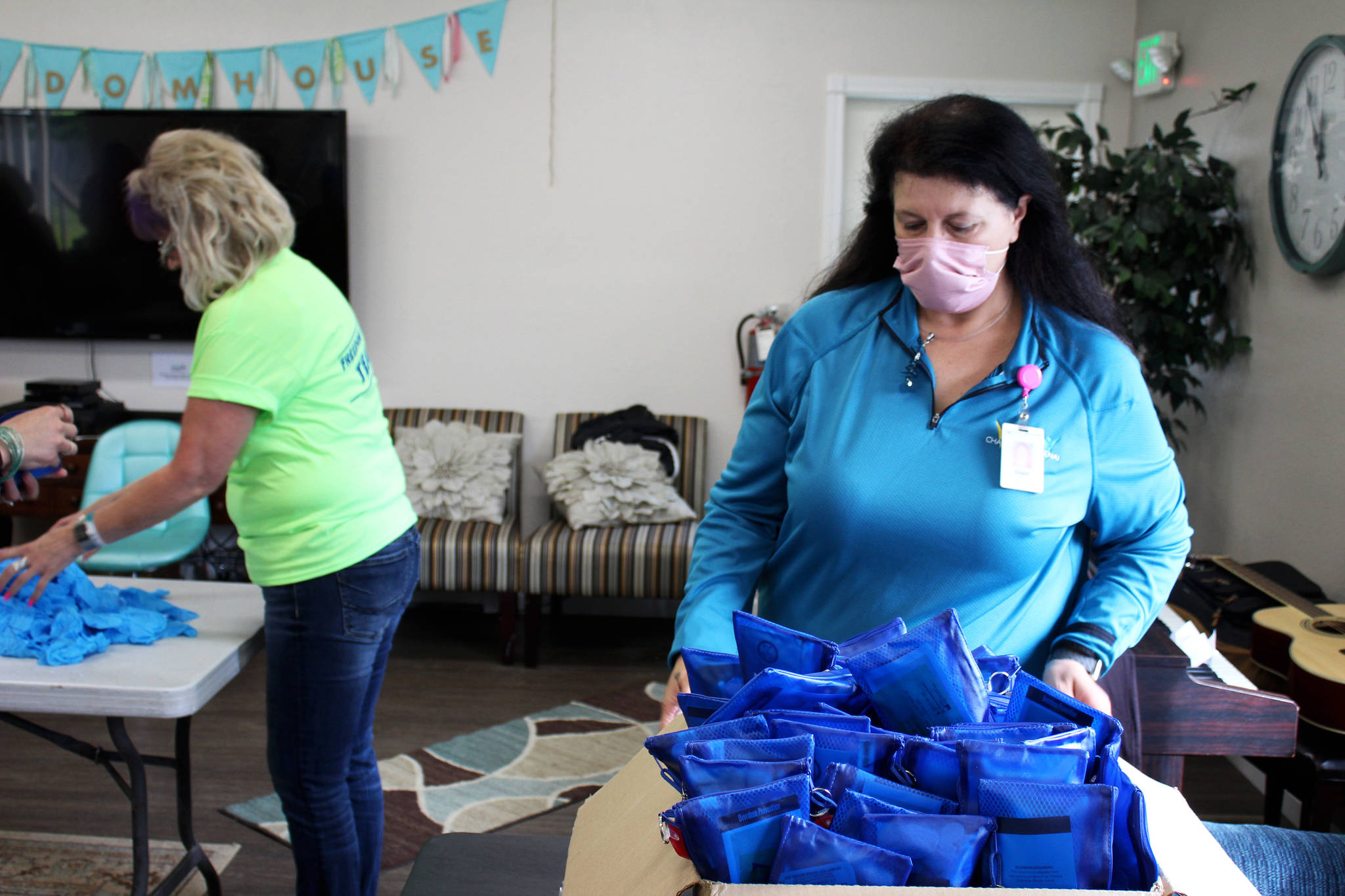 Shari Conner, a coalition coordinator for Change 4 the Kenai, adjusts a box of Narcan kits on Thursday, Aug. 12, 2021 at Freedom House in Soldotna, Alaska. (Ashlyn O’Hara/Peninsula Clarion)