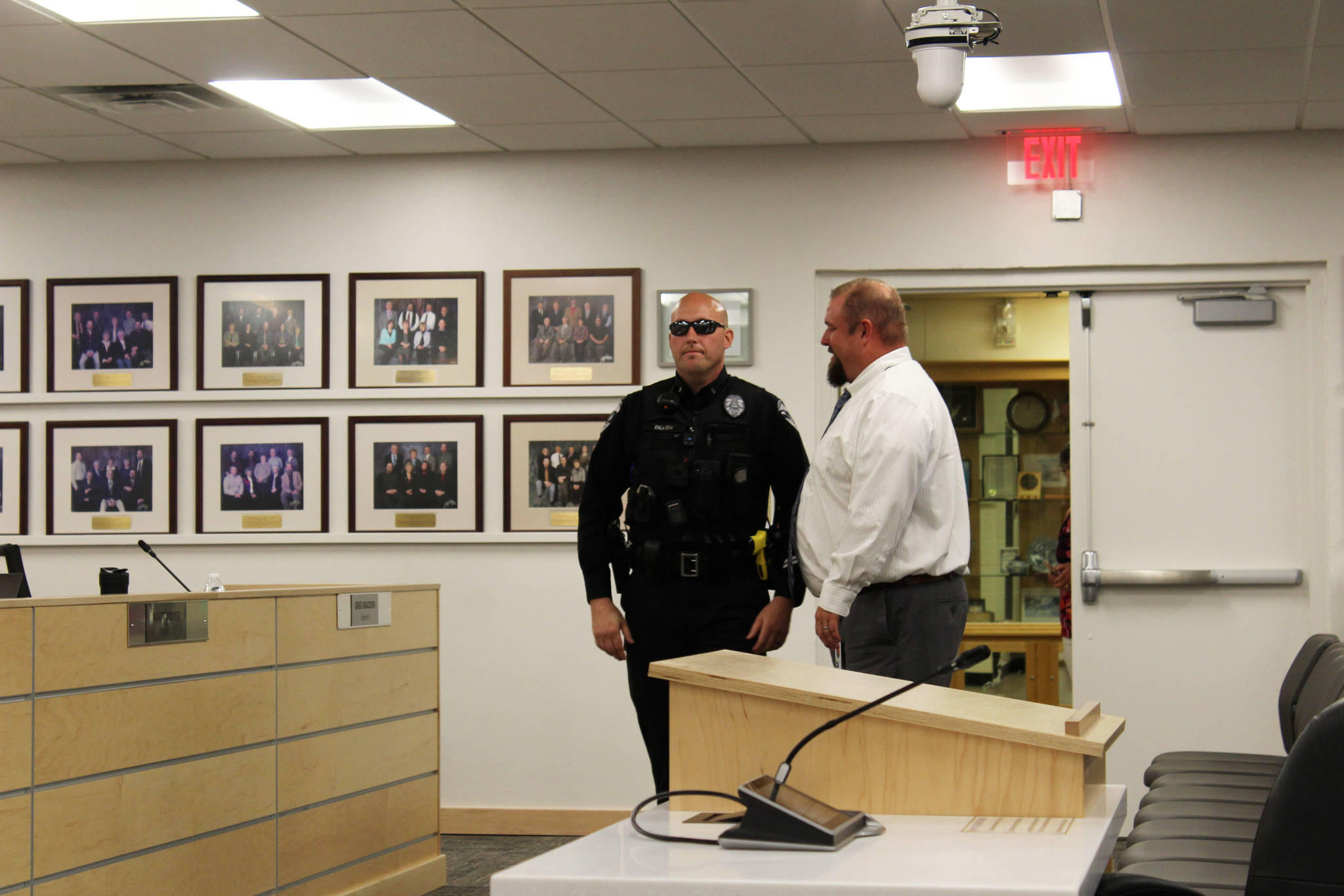 Officer Victor Dillon speaks with KPBSD Director of Secondary Education Tony Graham at the George A. Navarre Borough Admin building on Monday, Aug. 2, 2021 in Soldotna, Alaska. (Ashlyn O’Hara/Peninsula Clarion)