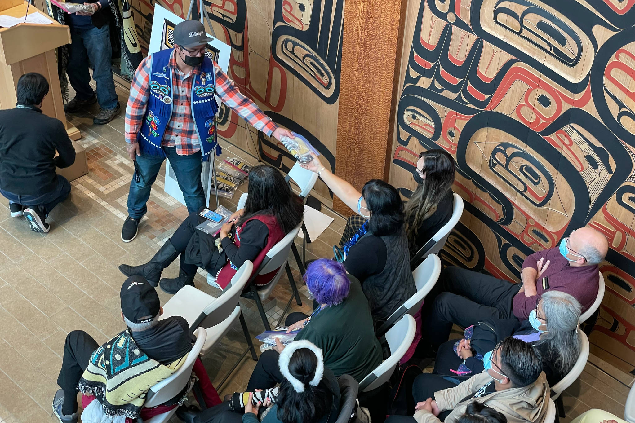 Michael S. Lockett / Juneau Empire
Participants in a ceremony commemorating the settlement of an intellectual property lawsuit against a fashion company take cuttings of the commercial garment at the center of the case on Friday, Aug. 13, 2021.