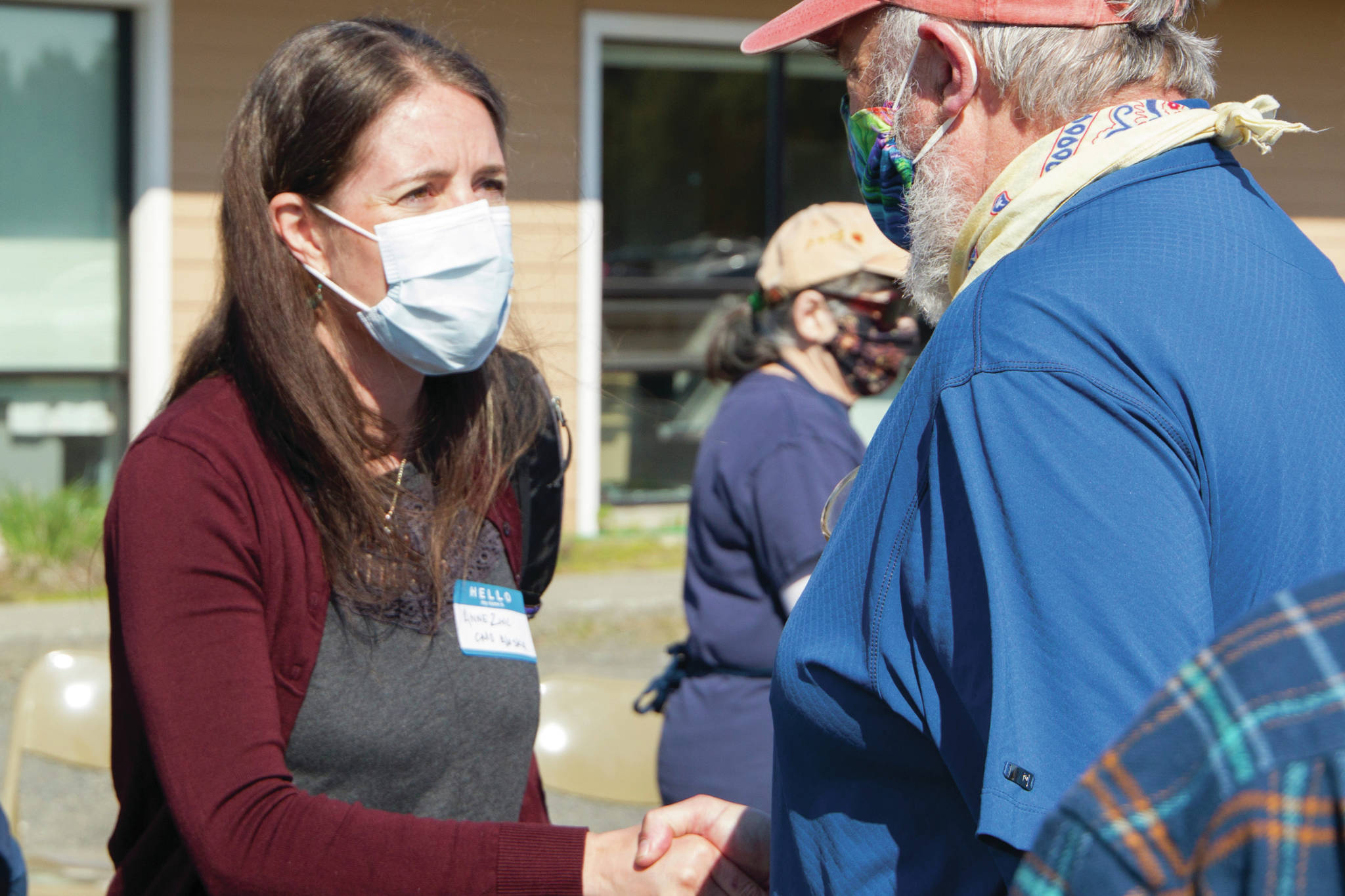 Alaska Chief Medical Officer Anne Zink, M.D., left, meets Homer Mayor Ken Castner, right, at a meet-and-greet on Thursday, May 27, 2021, at the Homer Public Health Center in Homer, Alaska. (Photo by Sarah Knapp/Homer News)