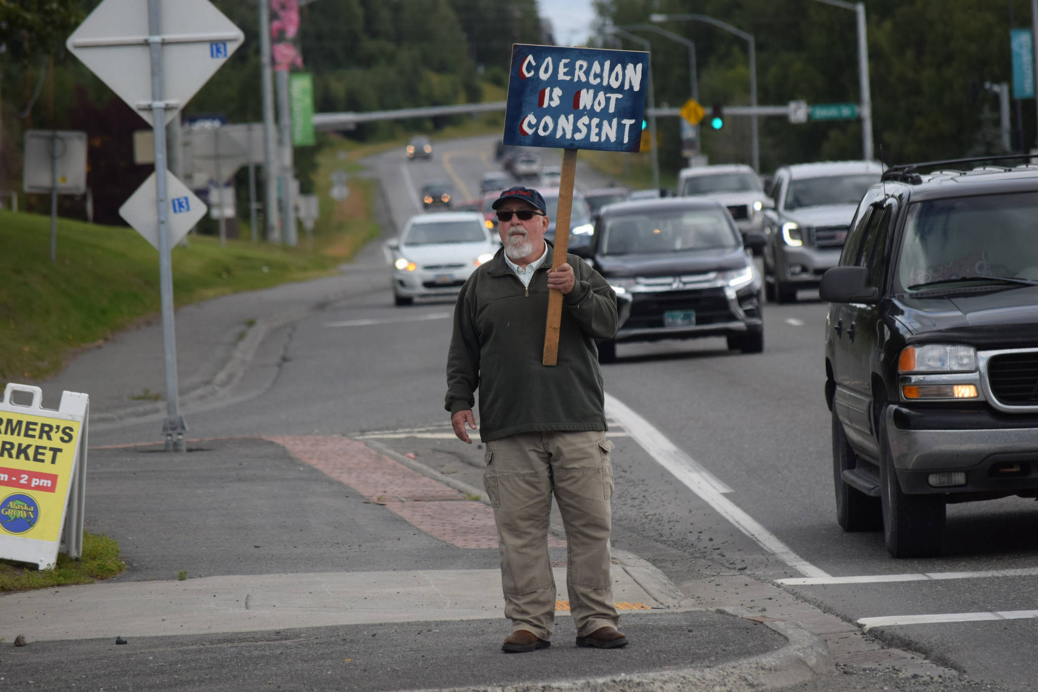 Kevin Hall stands at the “Y” intersection of the Kenai Spur and Sterling highways in Soldotna on Saturday, Aug. 14 to protest mandatory COVID-19 vaccines and mitigation protocols. (Camille Botello/Peninsula Clarion)