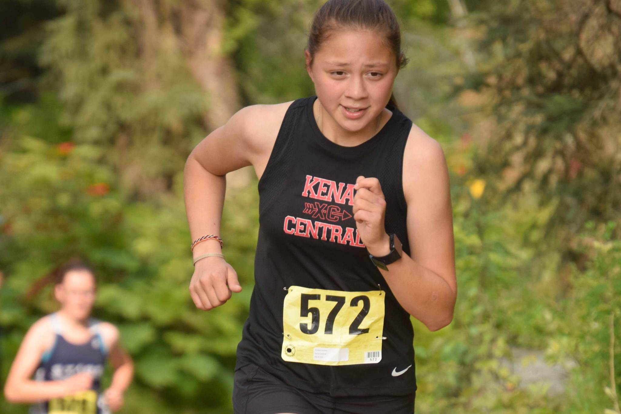 Kenai Central sophomore Emilee Wilson runs to victory in the freshmen-sophomore girls race in the Nikiski Class Races on Monday, Aug. 16, 2021, at Nikiski High School in Nikiski, Alaska. (Photo by Jeff Helminiak/Peninsula Clarion)