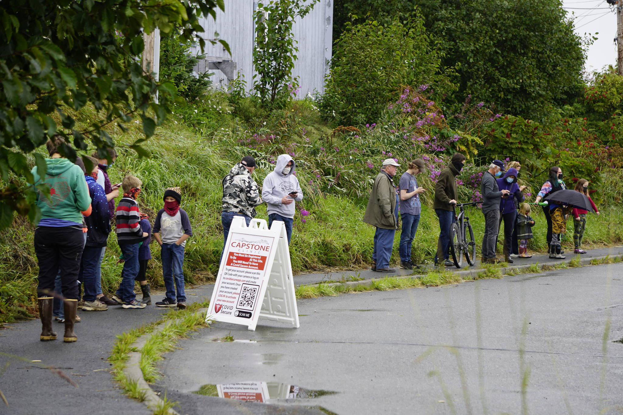 Almost 20 people wait in line at a Capstone Clinic pop-up COVID-19 testing clinic on Tuesday, Aug. 17, 2021, at the Homer Public Library in Homer, Alaska. The clinic offers same-day testing from noon-7:30 p.m. today and noon-4 p.m. Friday. (Photo by Michael Armstrong/Homer News).