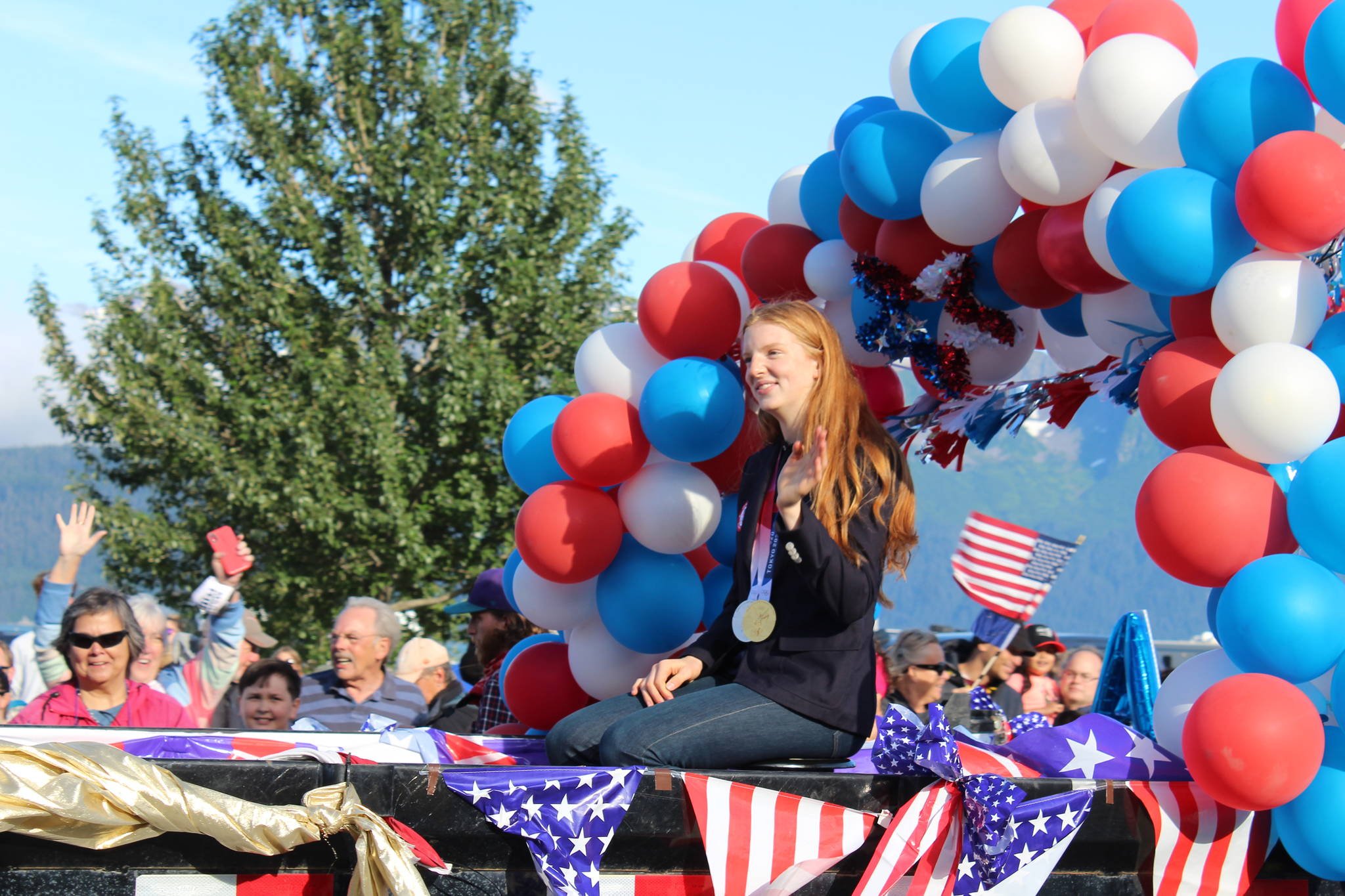 Olympic gold medalist Lydia Jacoby waves to the crowd in Seward during her celebratory parade on Thursday, August 5, 2021. (Ashlyn O’Hara/Peninsula Clarion)