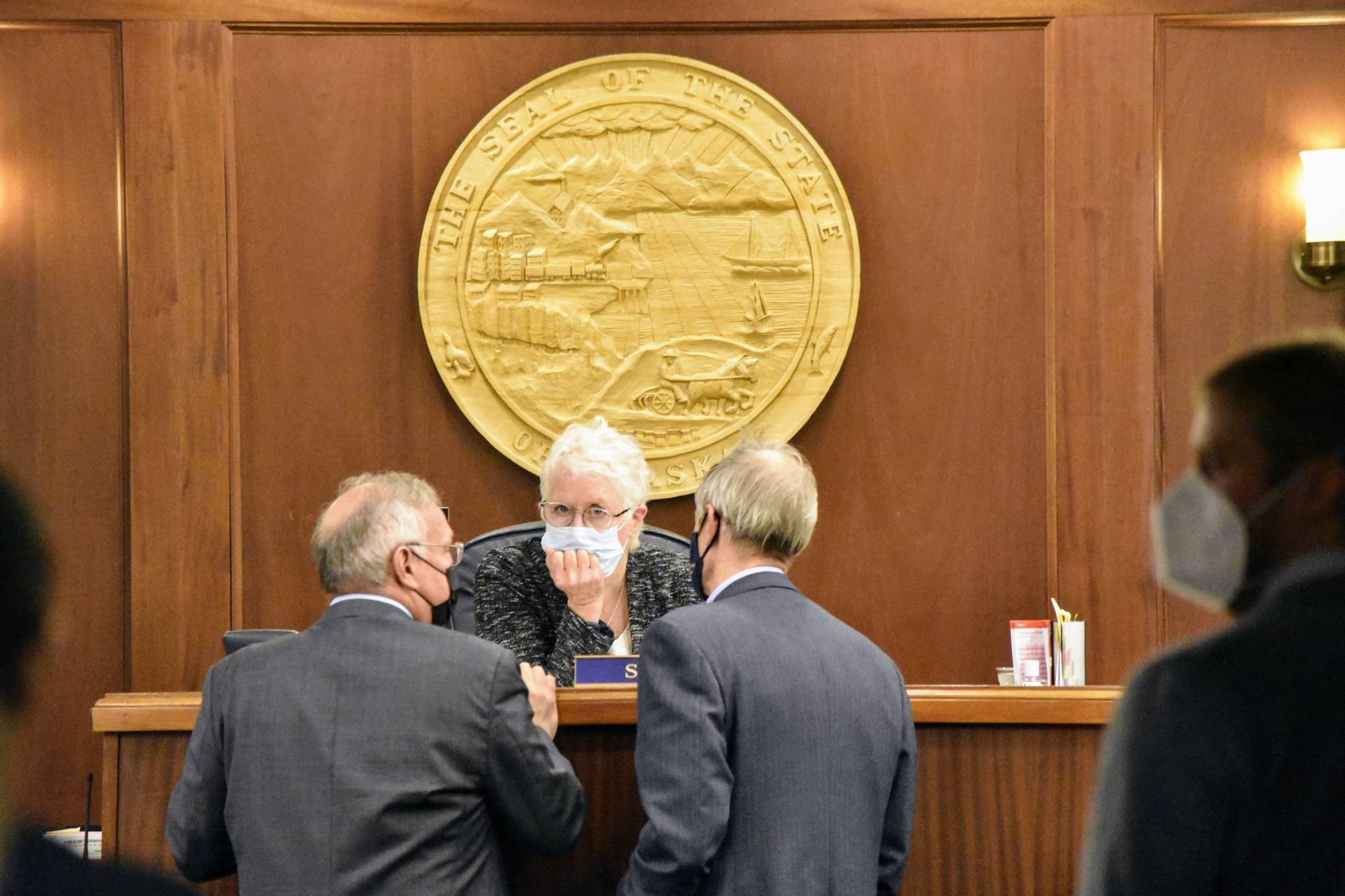 House Speaker Louise Stutes, R-Kodiak, speaks with Reps. Bryce Edgmon, I-Dillingham, and Matt Claman, D-Anchorage, on Wednesday, Aug. 25, 2021, as members of the House Republican Minority failed to show up for floor session. Divisions over the pace and direction of the special session has delayed legislative work. (Peter Segall / Juneau Empire)