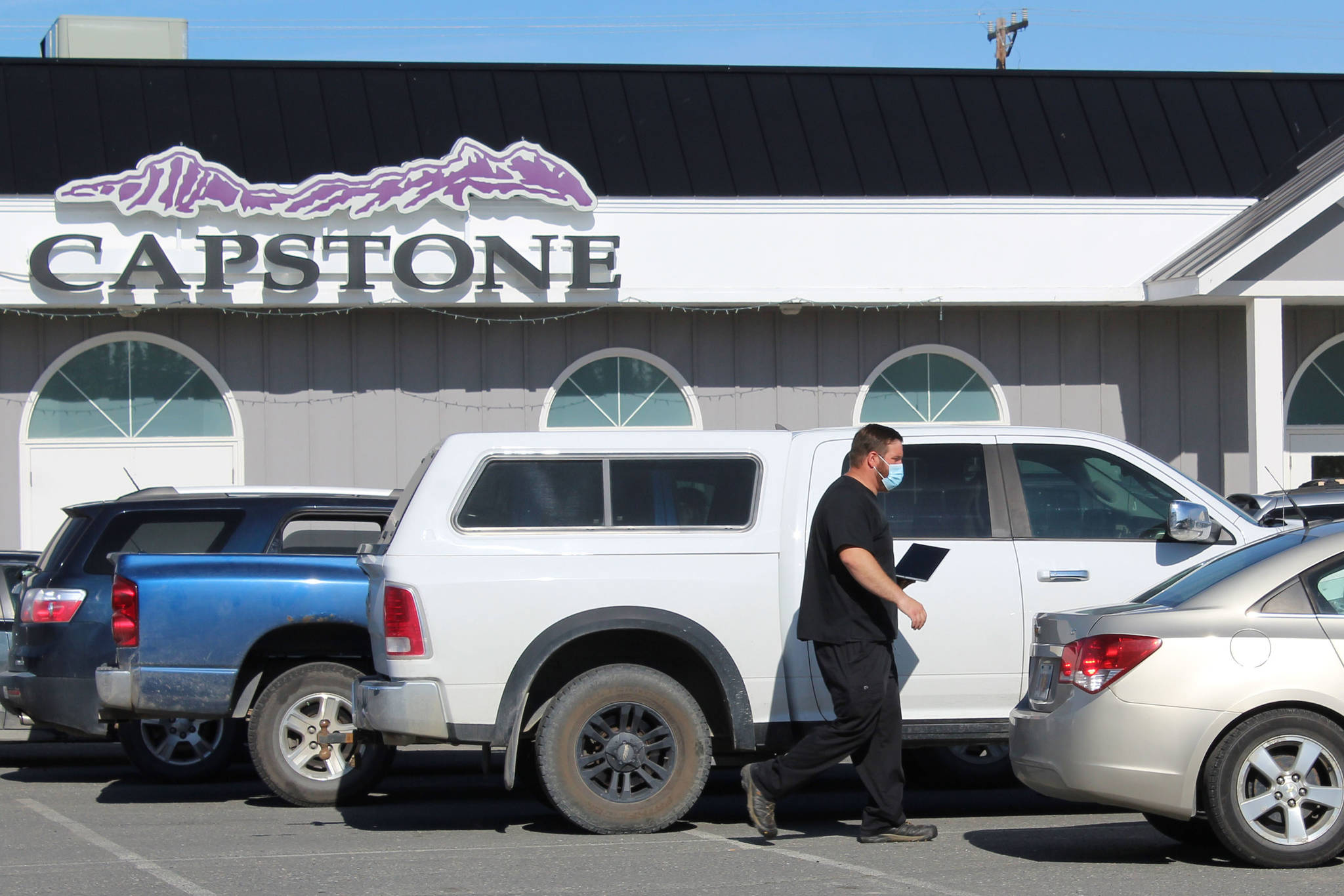Cars wait outside Capstone Clinic in Kenai, where COVID-19 testing is being offered, on Monday, Aug. 30, 2021 in Kenai, Alaska. The line at Capstone wound through the nearby Three Bears parking lot. (Ashlyn O’Hara/Peninsula Clarion)