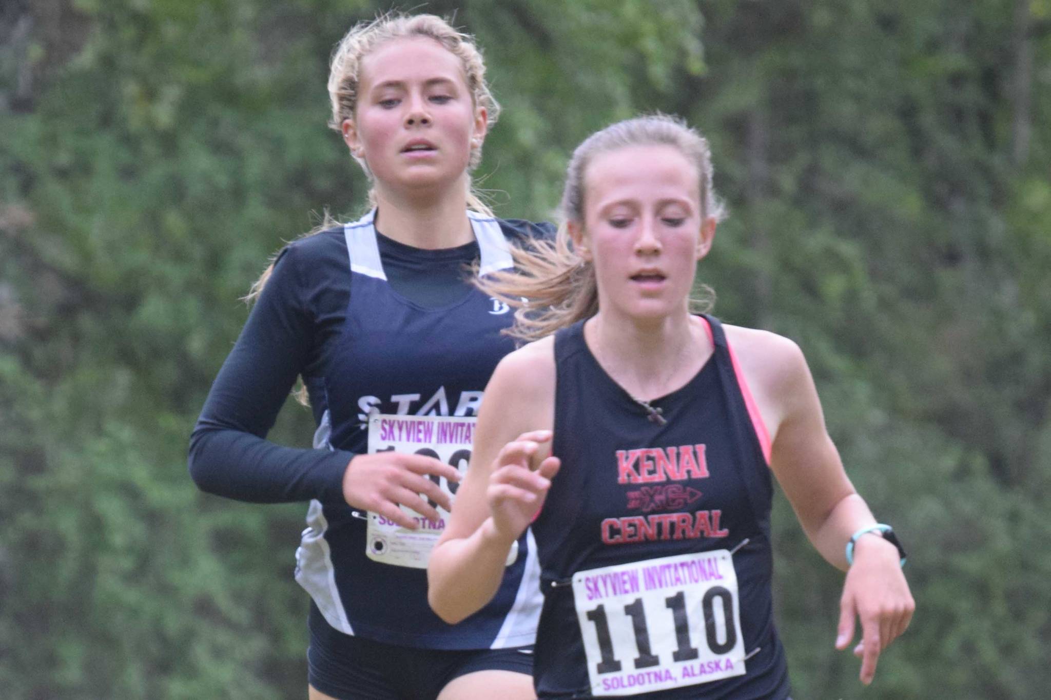 Soldotna's Jordan Strausbaugh tries to find a way around Kenai Central's Jayna Boonstra on Wednesday, Sept. 1, 2021, at the Kenai-Soldotna dual meet at Tsalteshi Trails just outside of Soldotna, Alaska. Boonstra was able to hang on for first place in the race. (Photo by Jeff Helminiak/Peninsula Clarion)