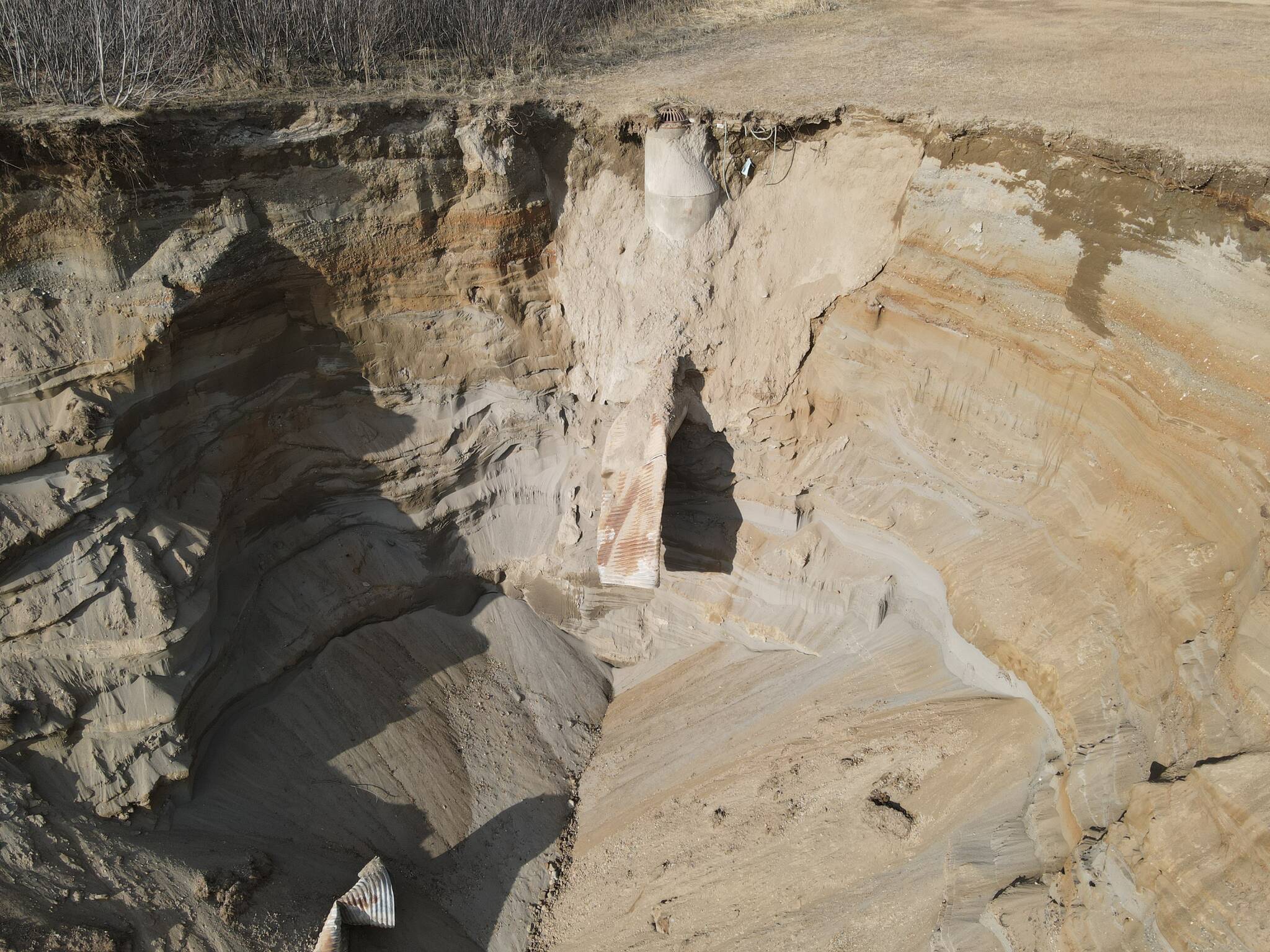 A bluff near Bryson Avenue erodes following failure of a rusty pipe. (Photo courtesy of the City of Kenai)