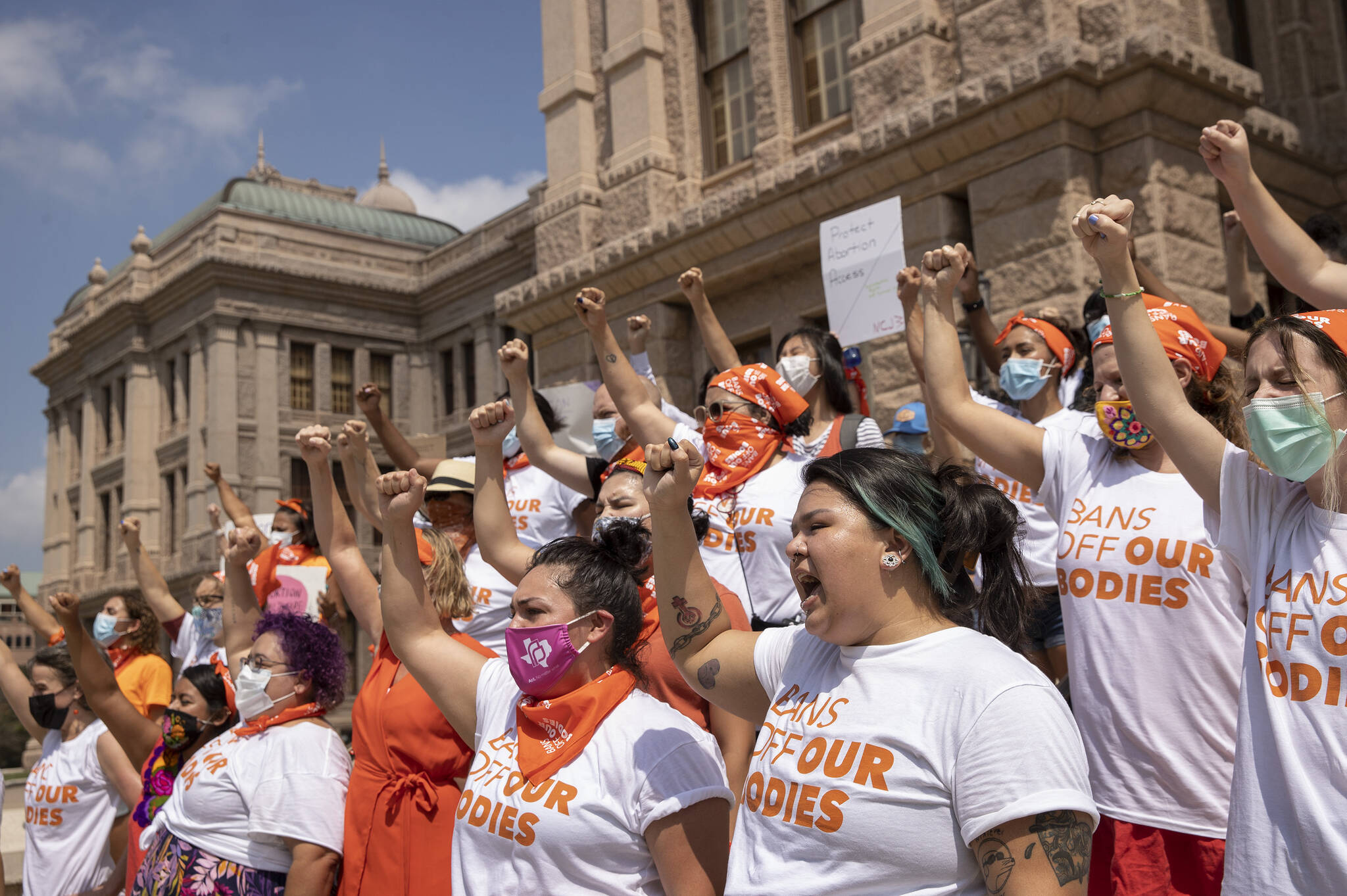 In this Sept. 1, 2021 file photo, women protest against the six-week abortion ban at the Capitol in Austin, Texas. Even before a strict abortion ban took effect in Texas this week, clinics in neighboring states were fielding more and more calls from women desperate for options. The Texas law, allowed to stand in a decision Thursday, Sept. 2, 2021 by the U.S. Supreme Court, bans abortions after a fetal heartbeat can be detected, typically around six weeks. (Jay Janner/Austin American-Statesman via AP File)