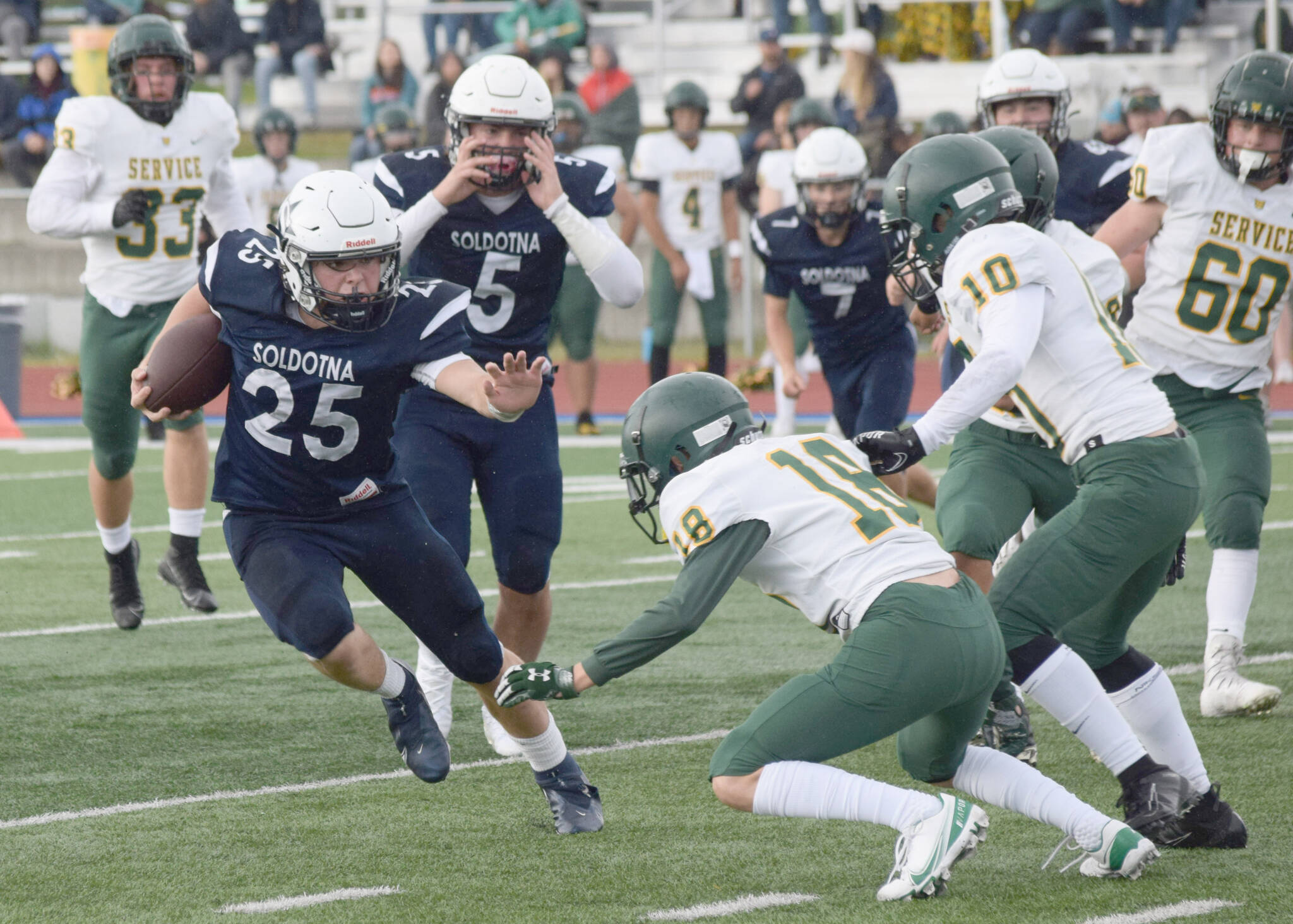 Soldotna’s Gehret Medcoff rushes against Service at Justin Maile Field on Friday, Sept. 3, 2021, in Soldotna, Alaska. (Photo by Camille Botello/Peninsula Clarion)