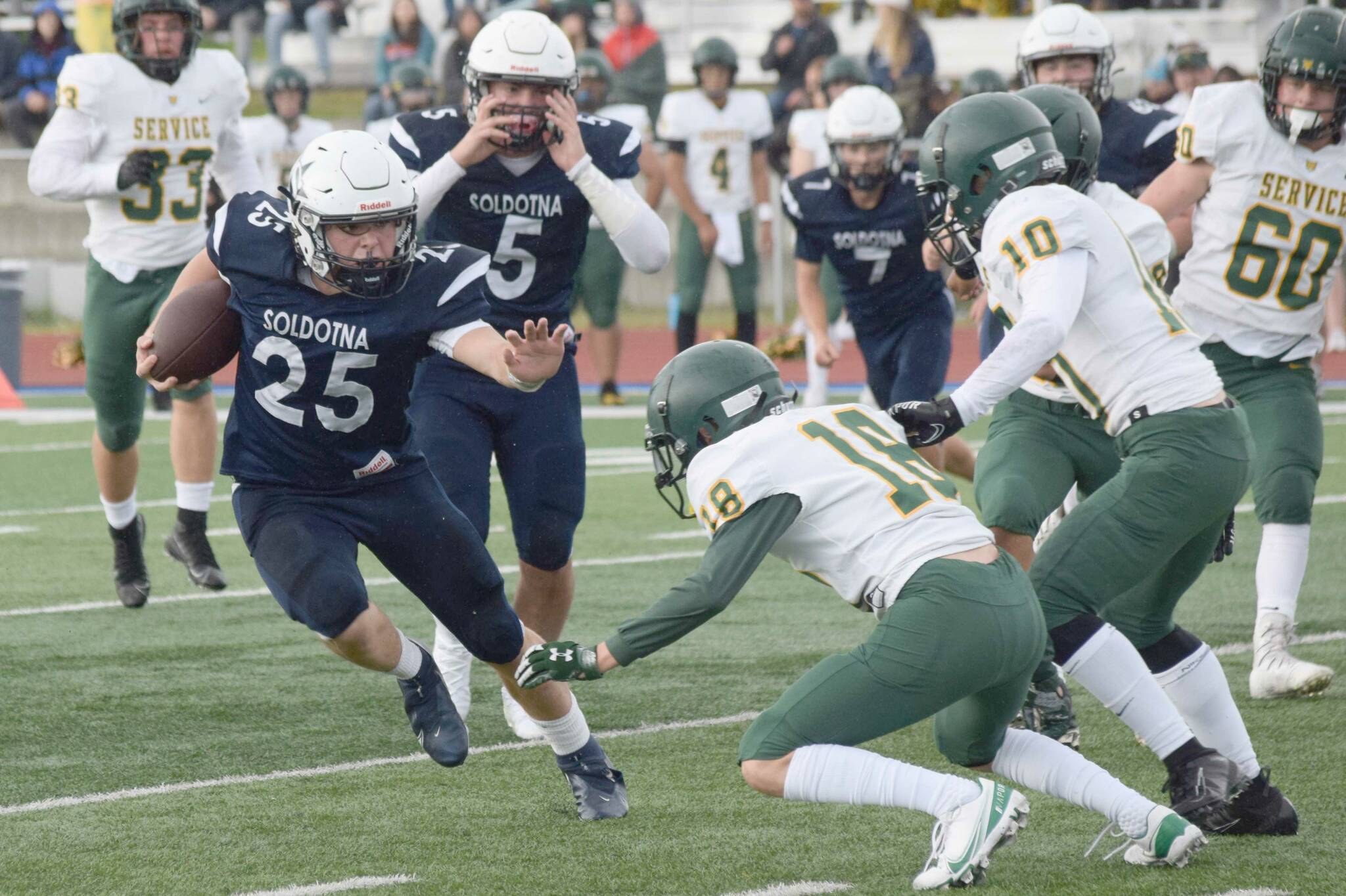 Soldotna's Gehret Medcoff rushes against Service at Justin Maile Field on Friday, Sept. 3, 2021, in Soldotna, Alaska. (Photo by Camille Botello/Peninsula Clarion)